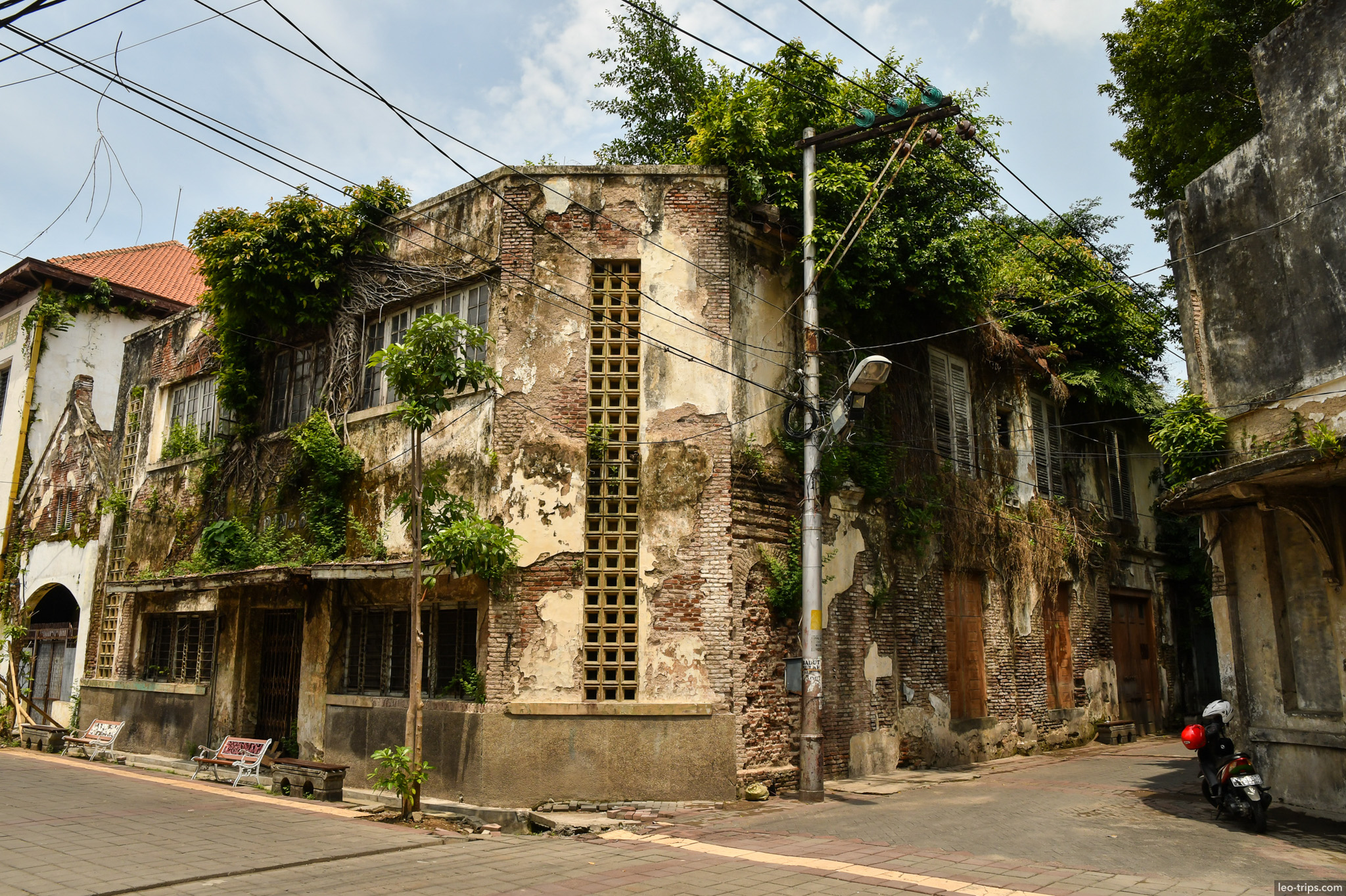abandoned colonial corner building overgrown semarang