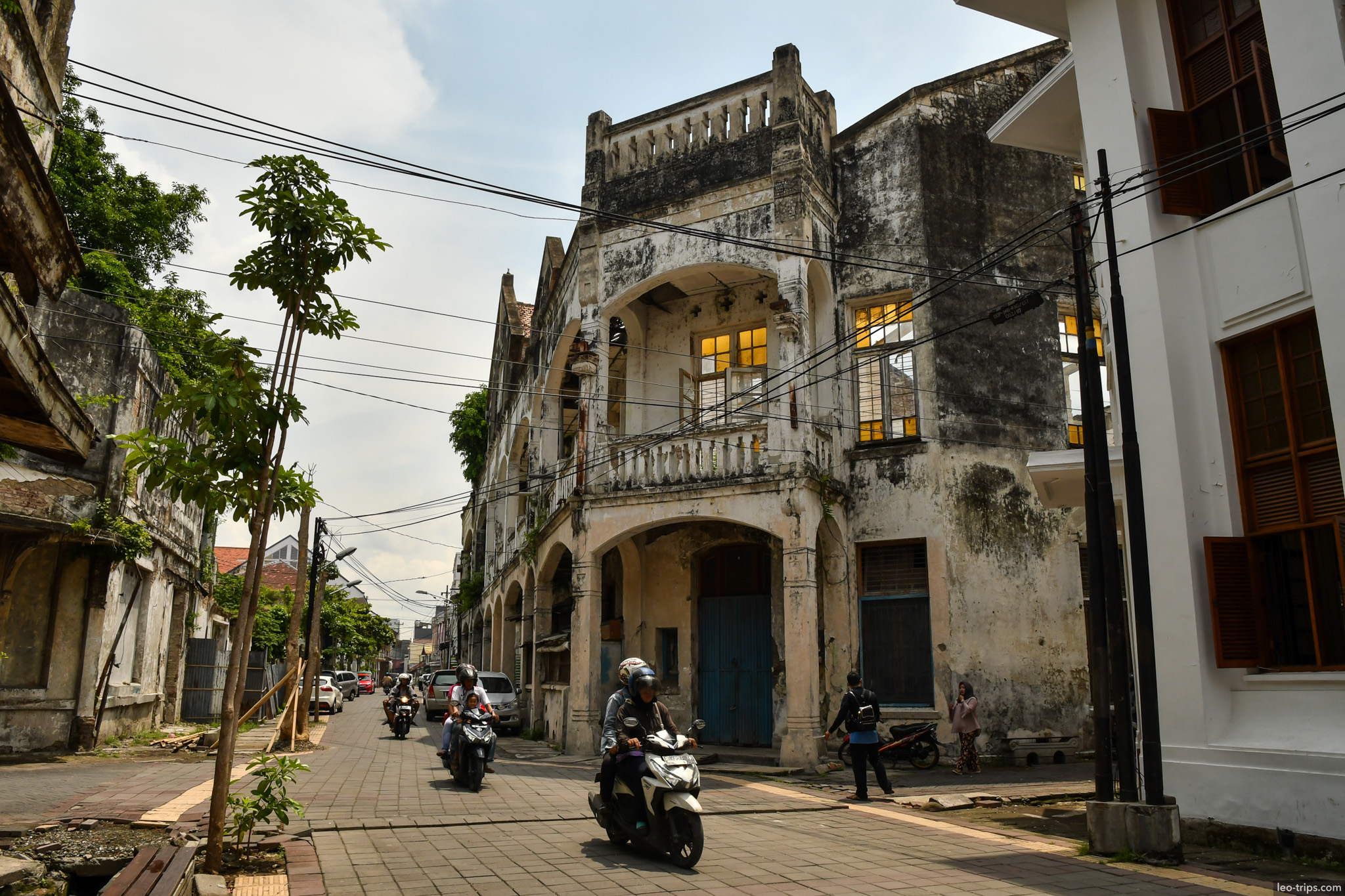 colonial building with balcony scooters kota lama semarang