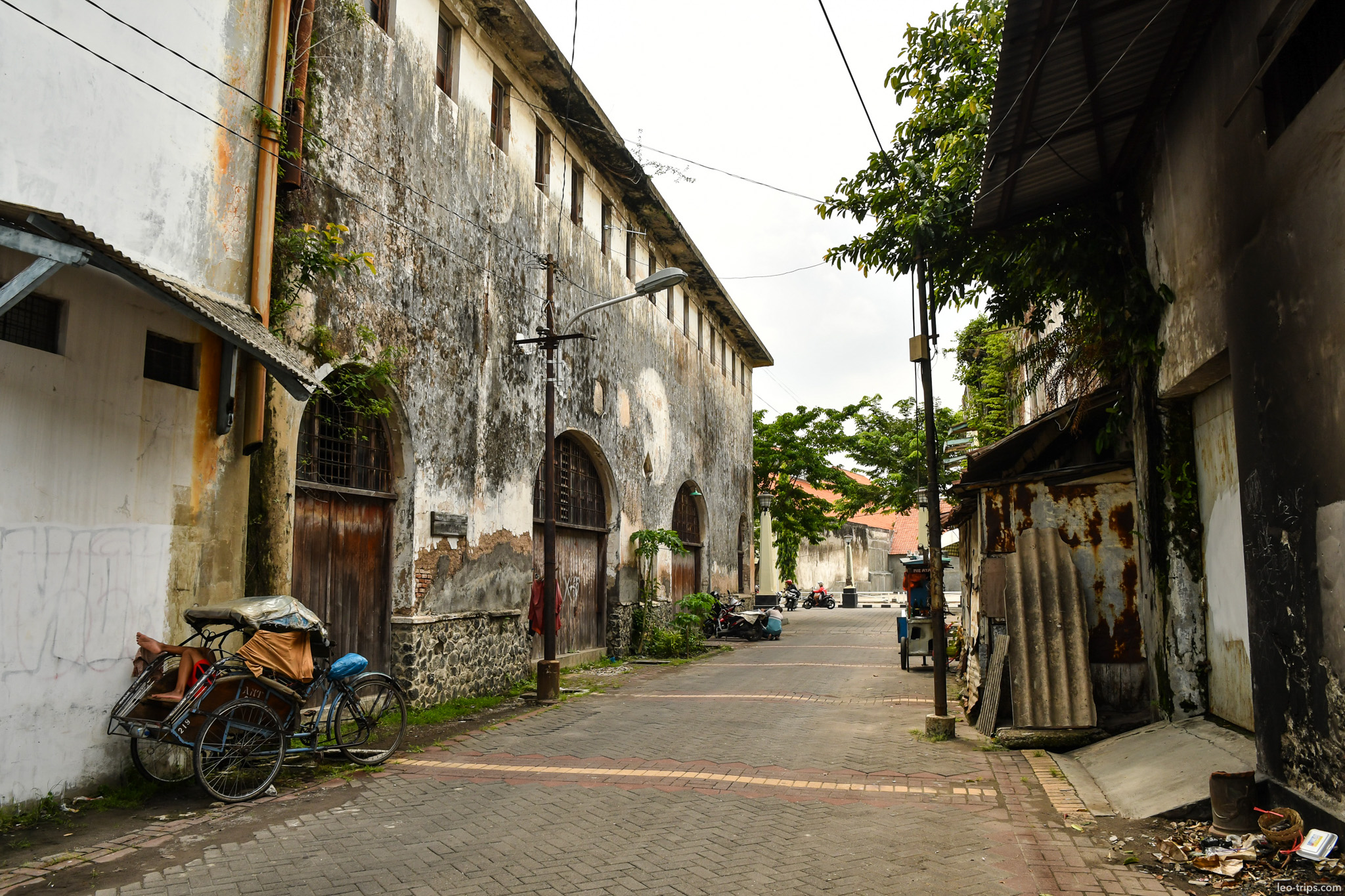 old colonial warehouse alley with becak semarang