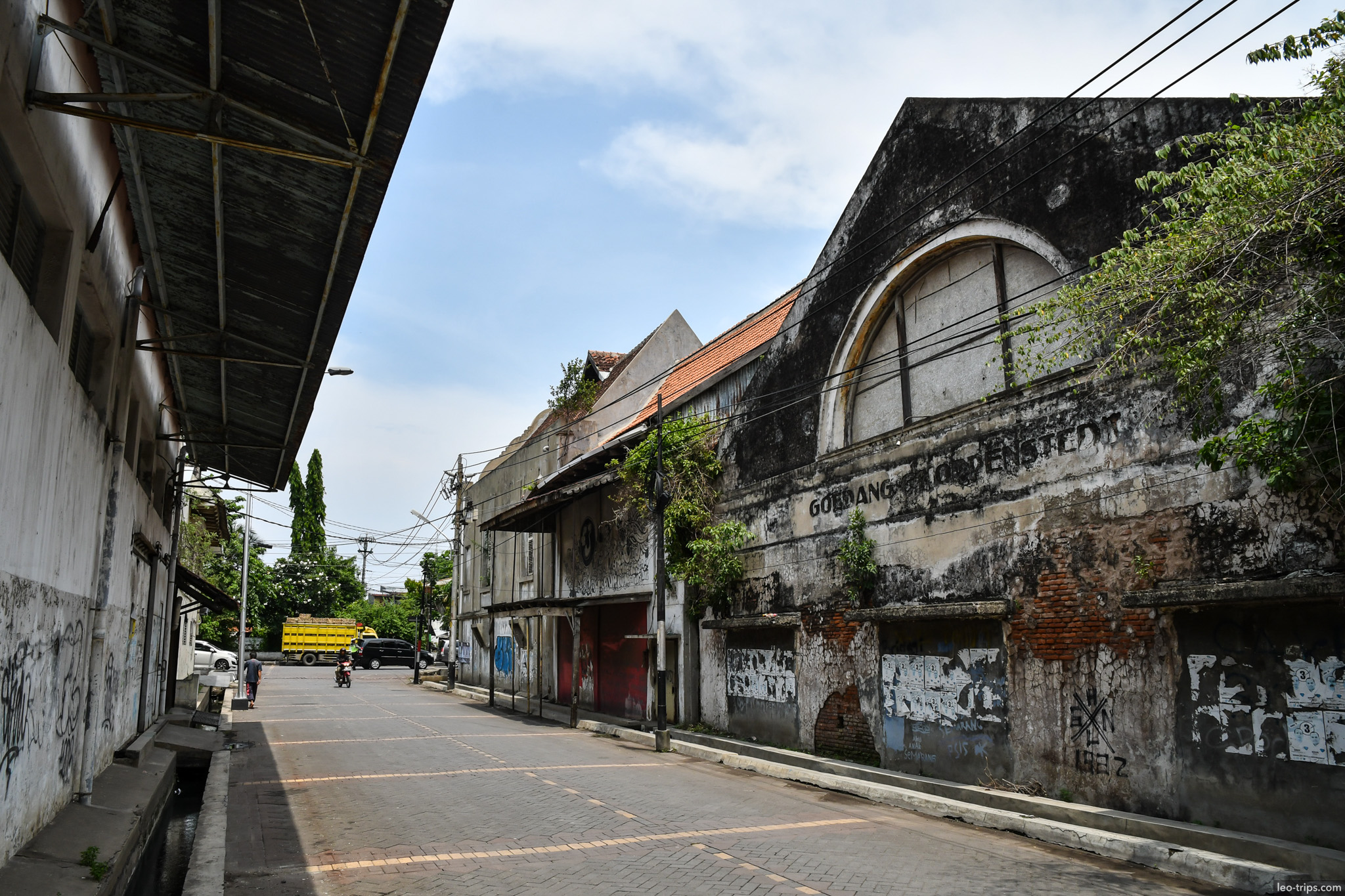 old dutch warehouse arched facade overgrown semarang