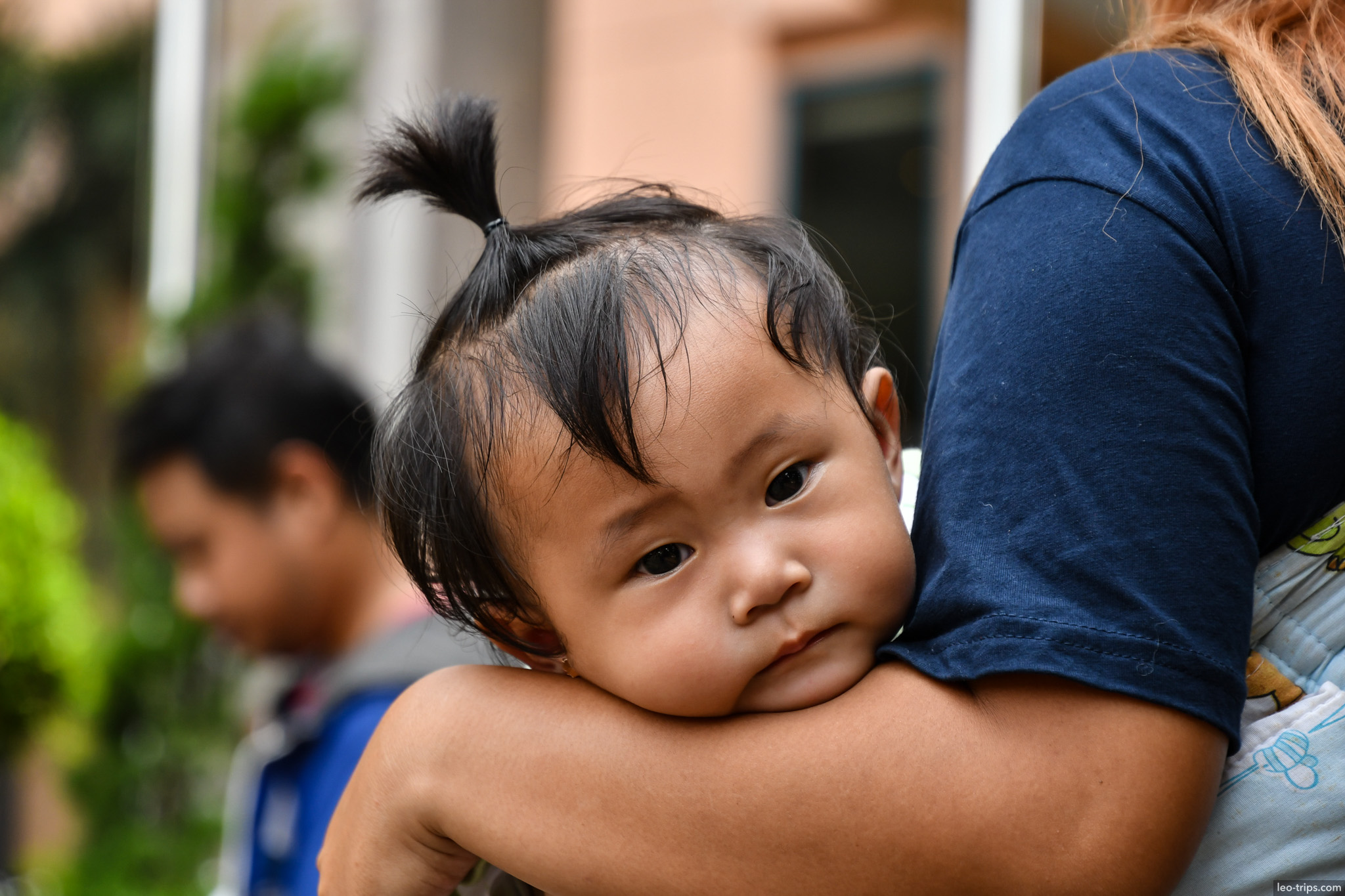 toddler with pigtails resting on mothers arm semarang