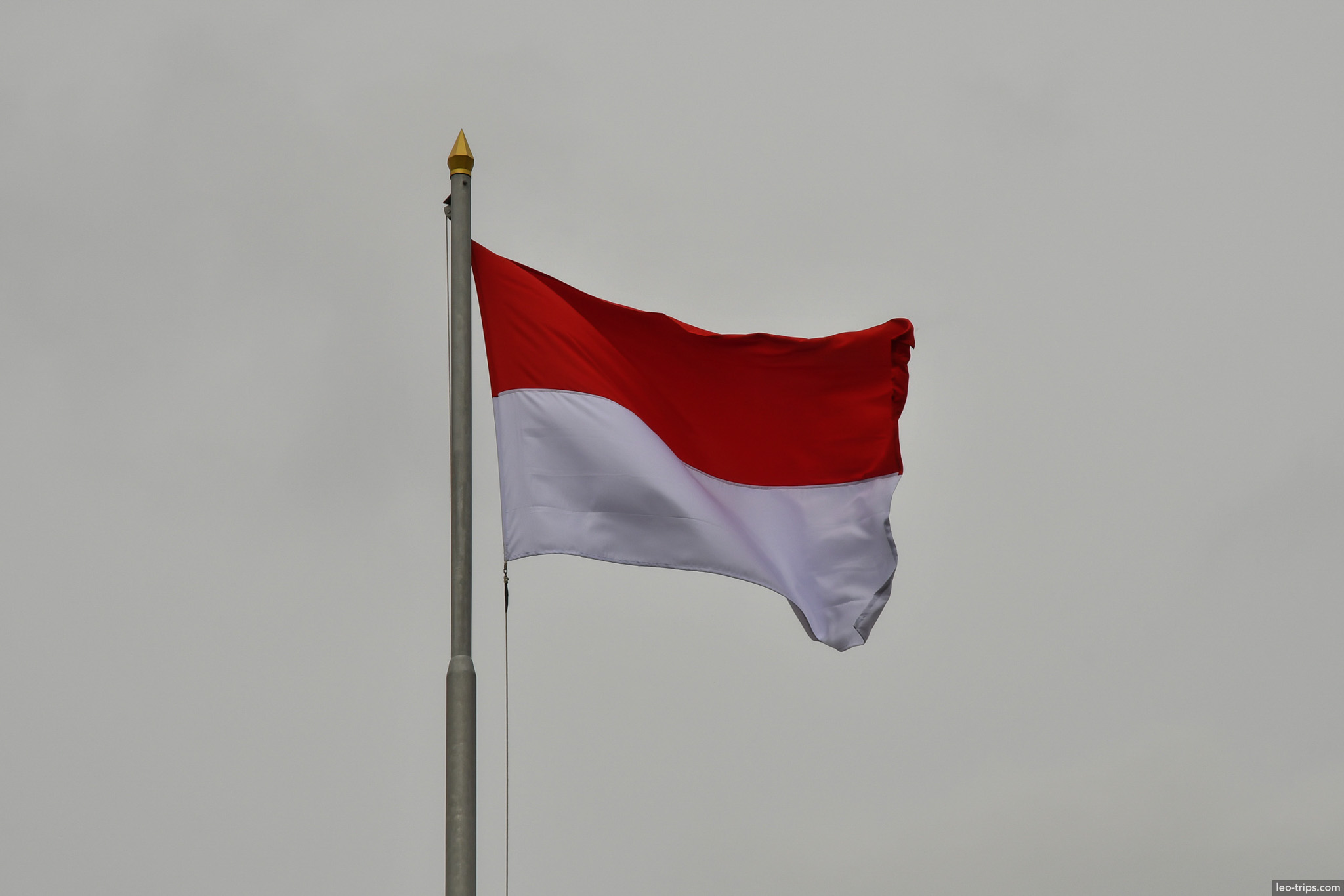 indonesian red white flag waving golden finial surabaya