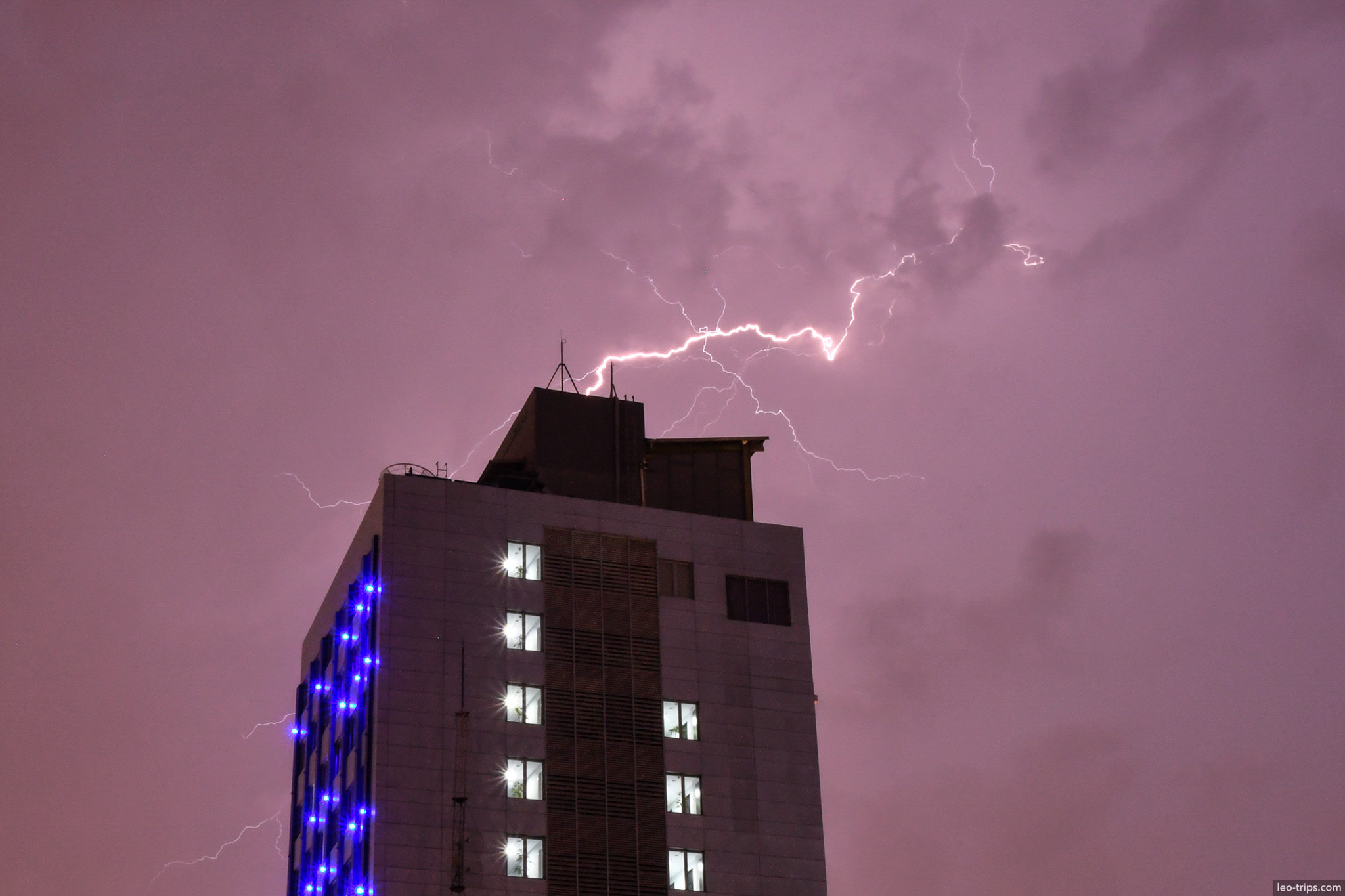 lightning bolt over high rise building night surabaya