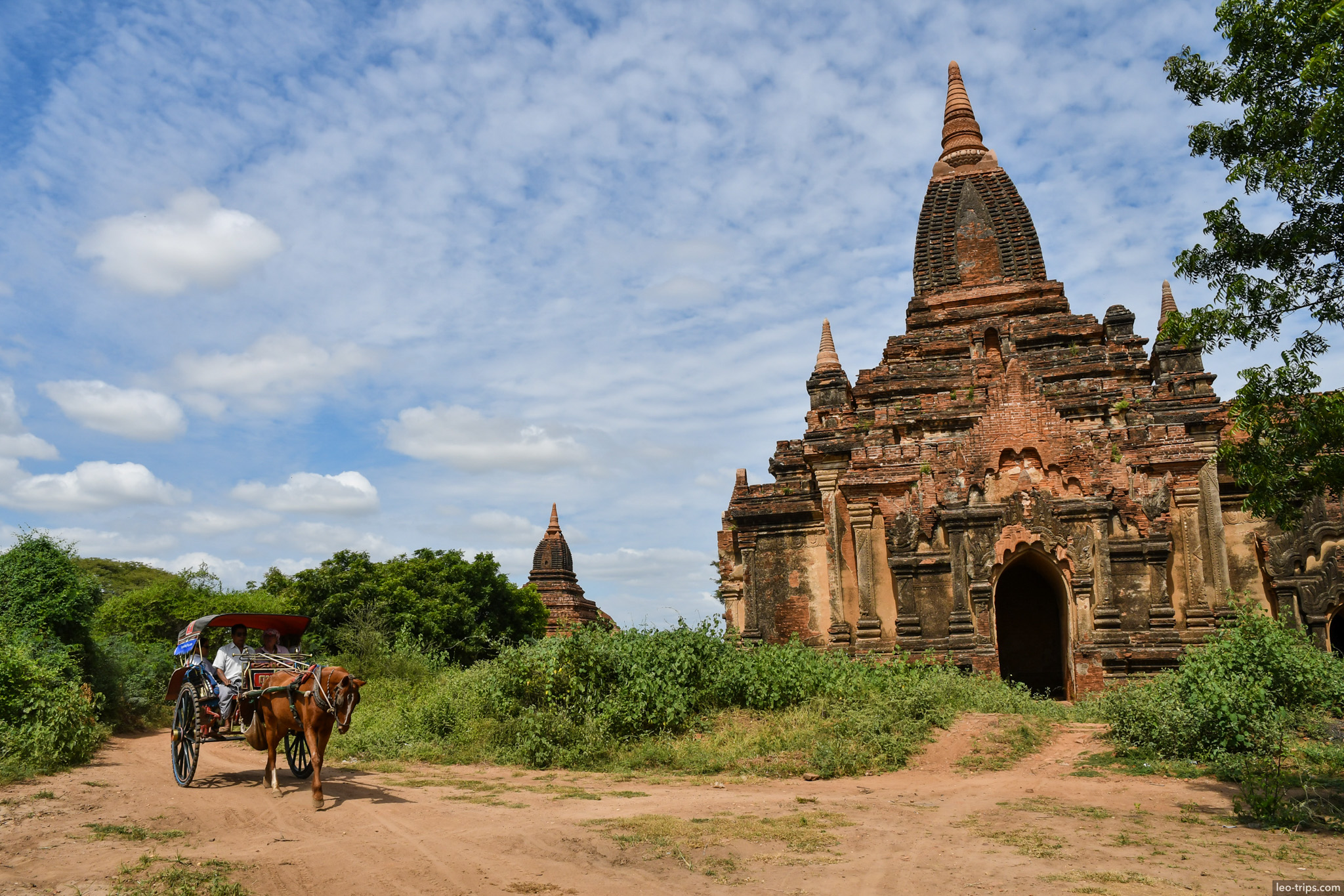 horse cart passing brick temple dirt road bagan bagan