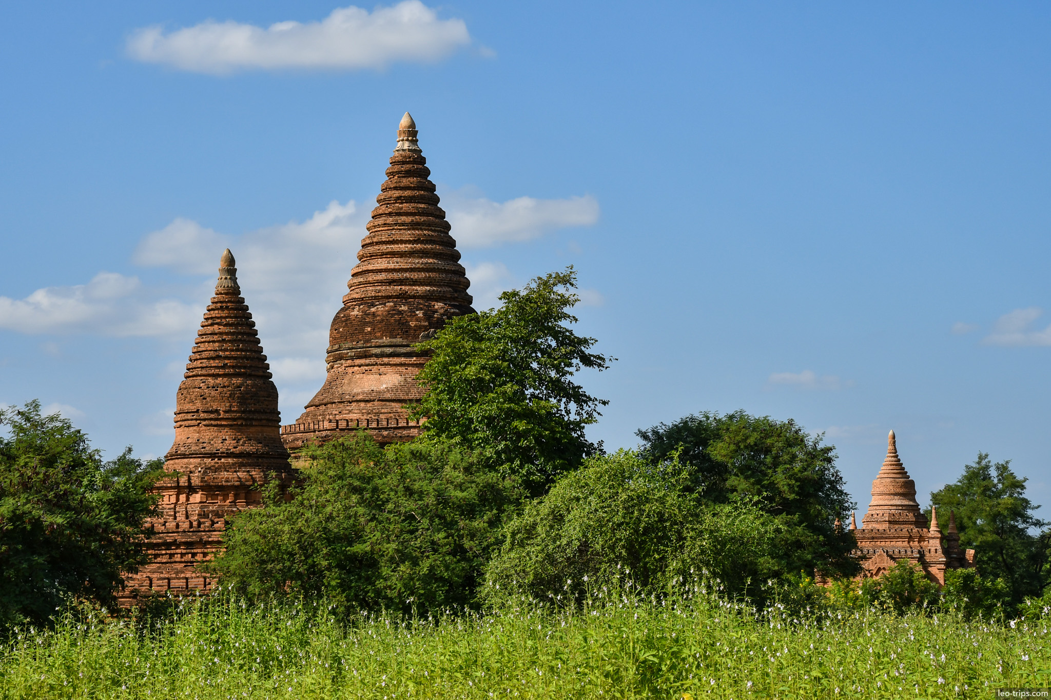 twin conical stupas in green field bagan bagan