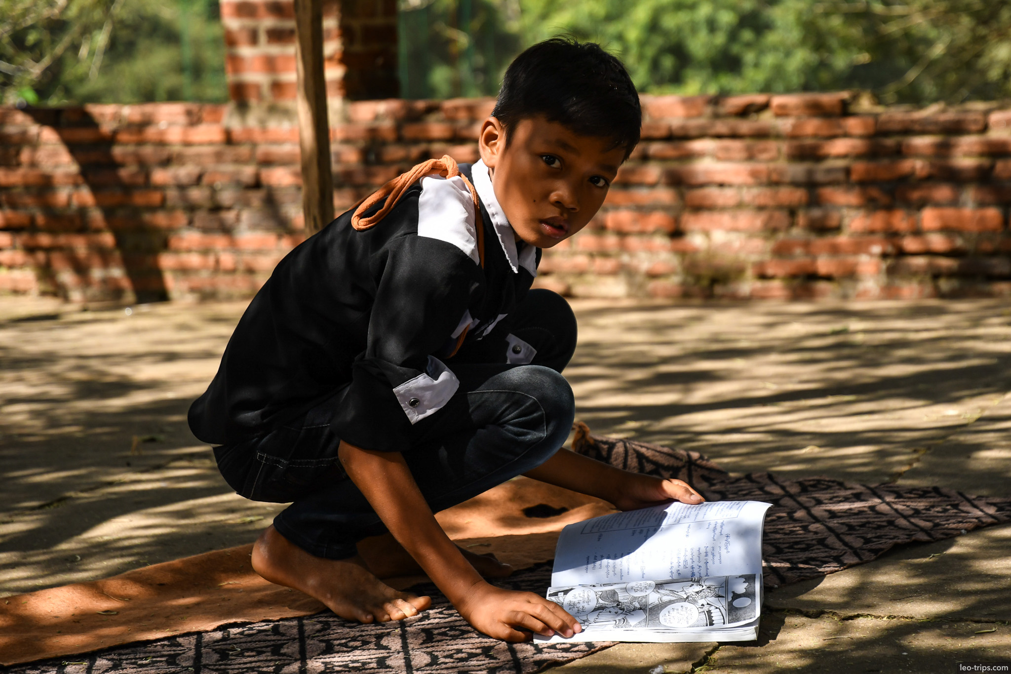 young boy reading book at temple bagan bagan