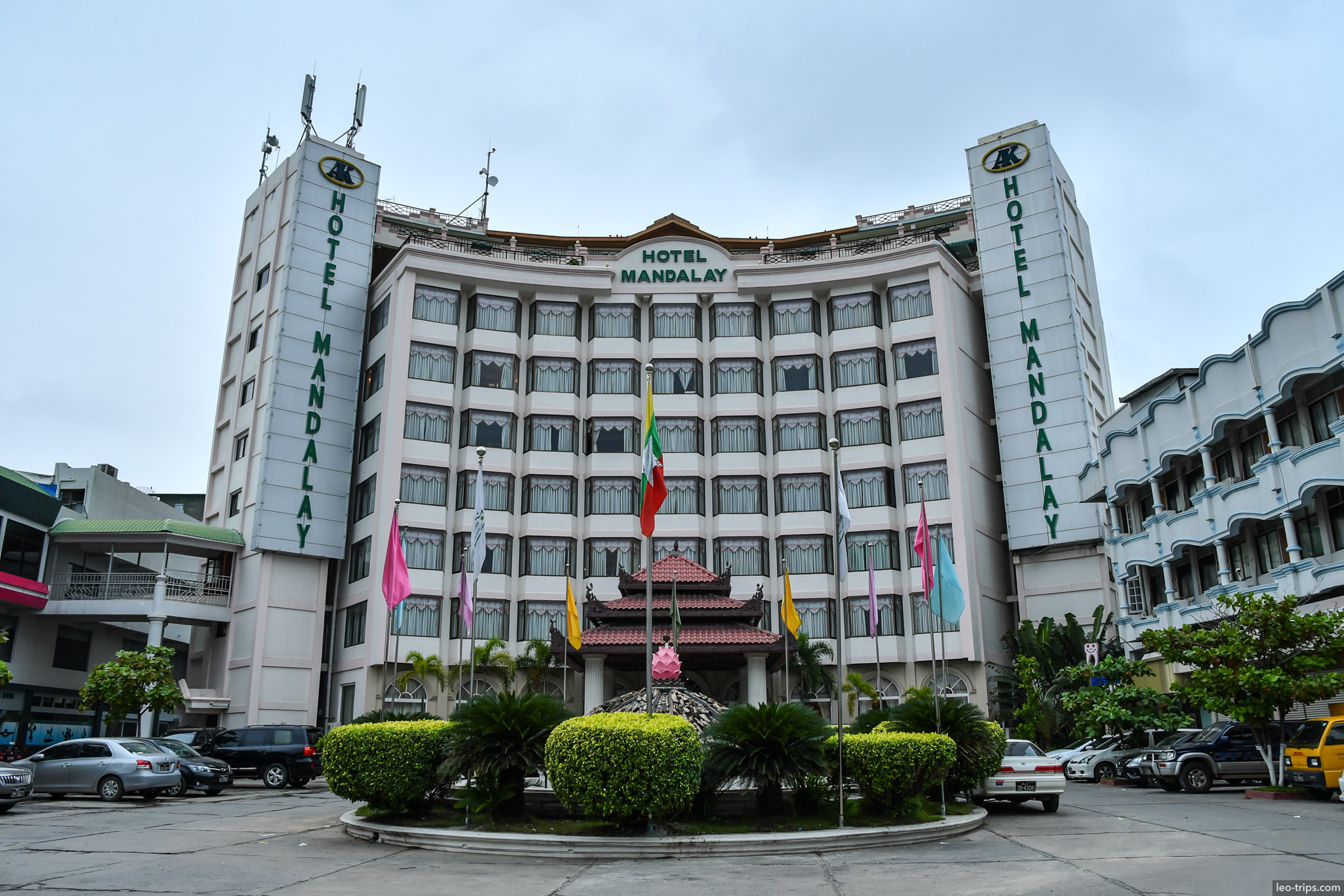 large hotel building with colorful flags mandalay mandalay