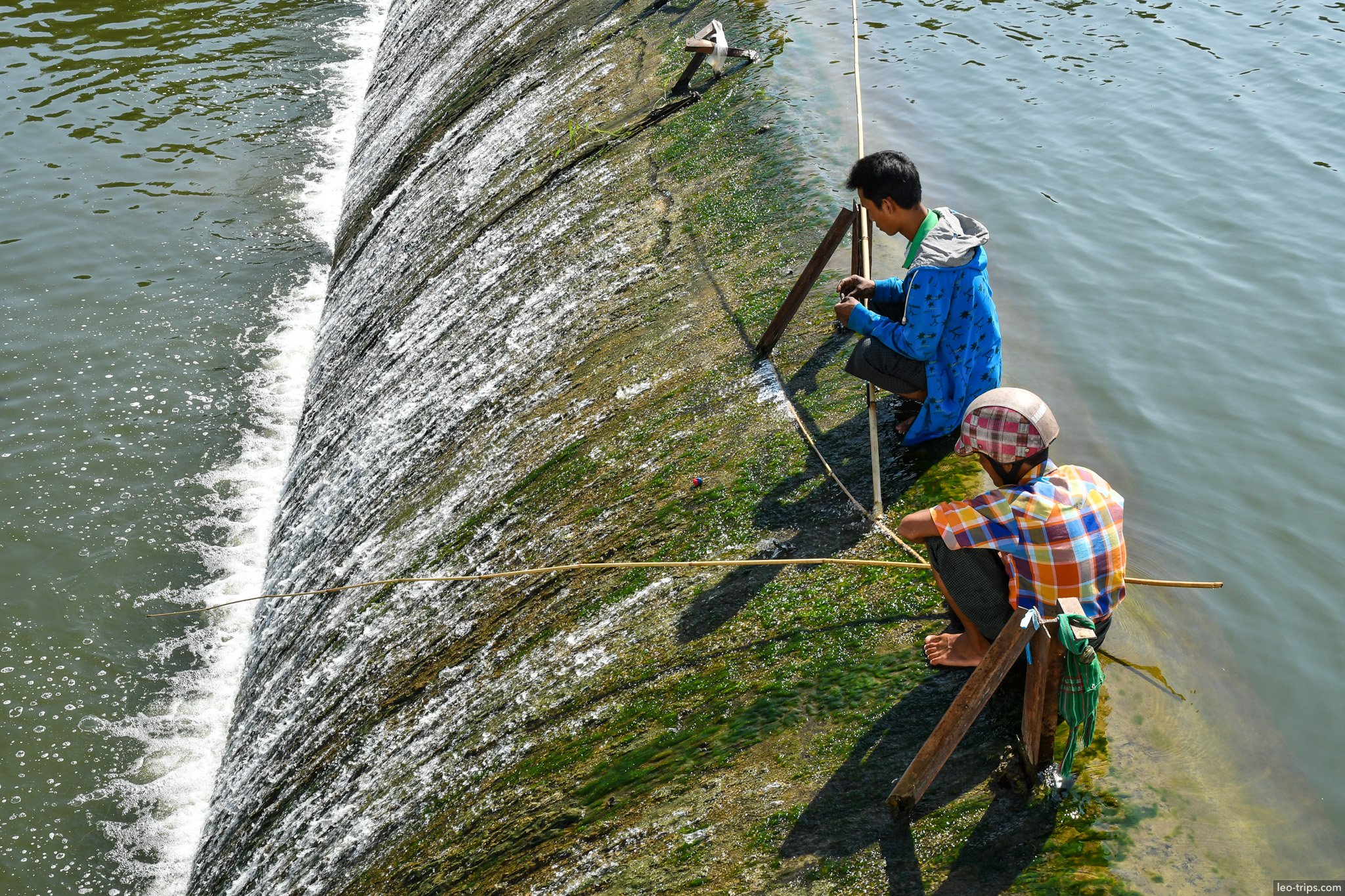 fishermen on dam spillway closeup naypyidaw naypyidaw