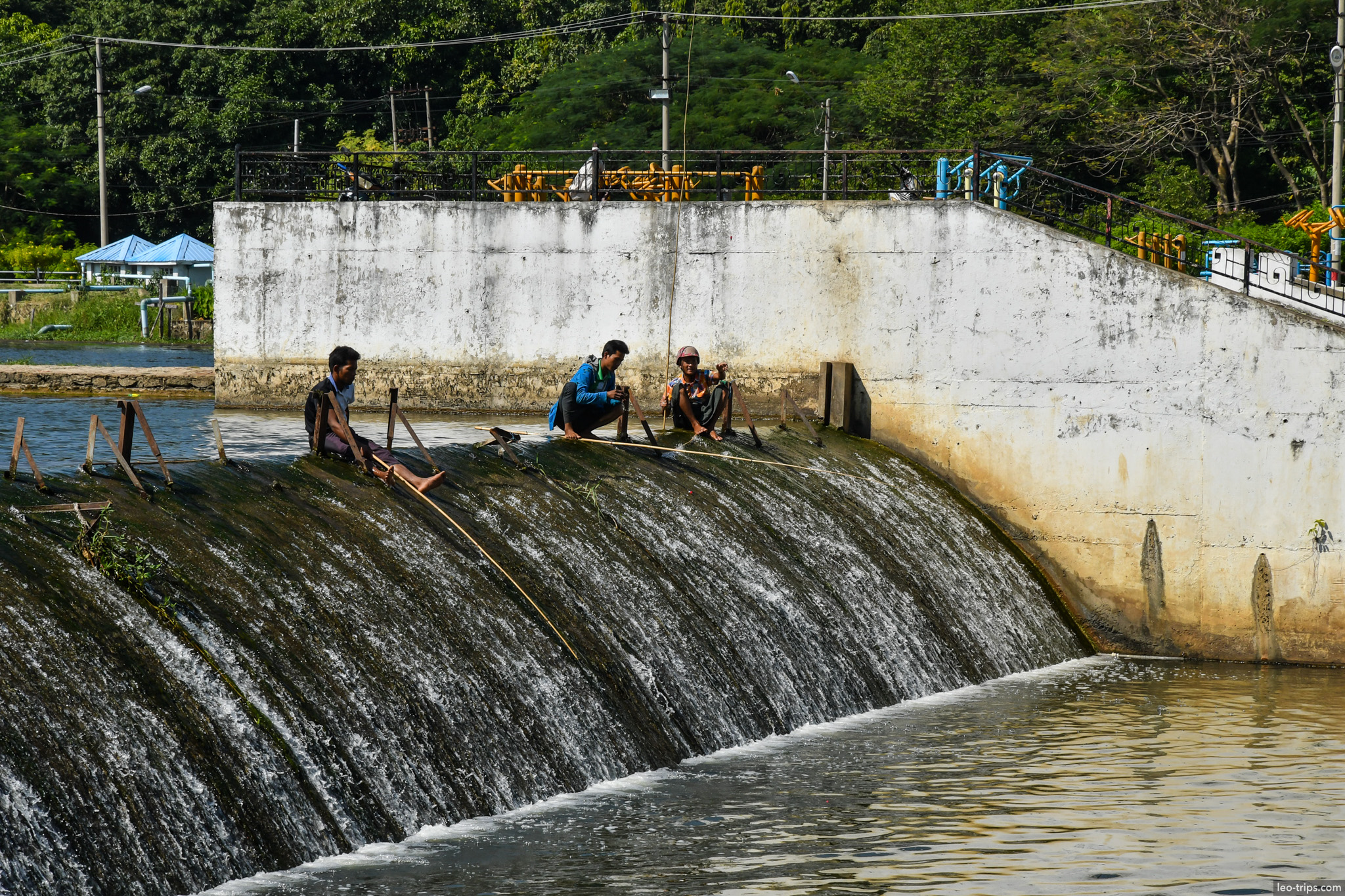 three fishermen on concrete dam naypyidaw naypyidaw