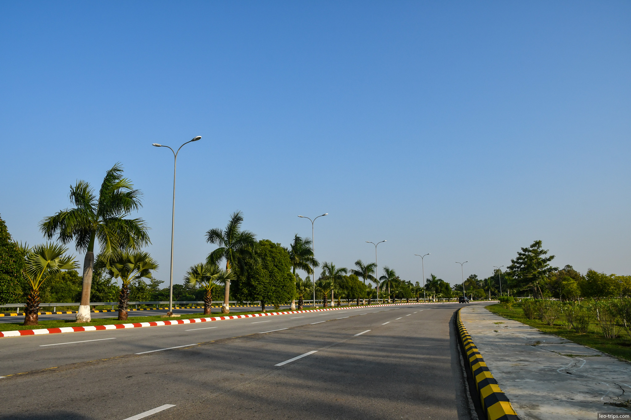 wide empty boulevard with palm trees naypyidaw naypyidaw