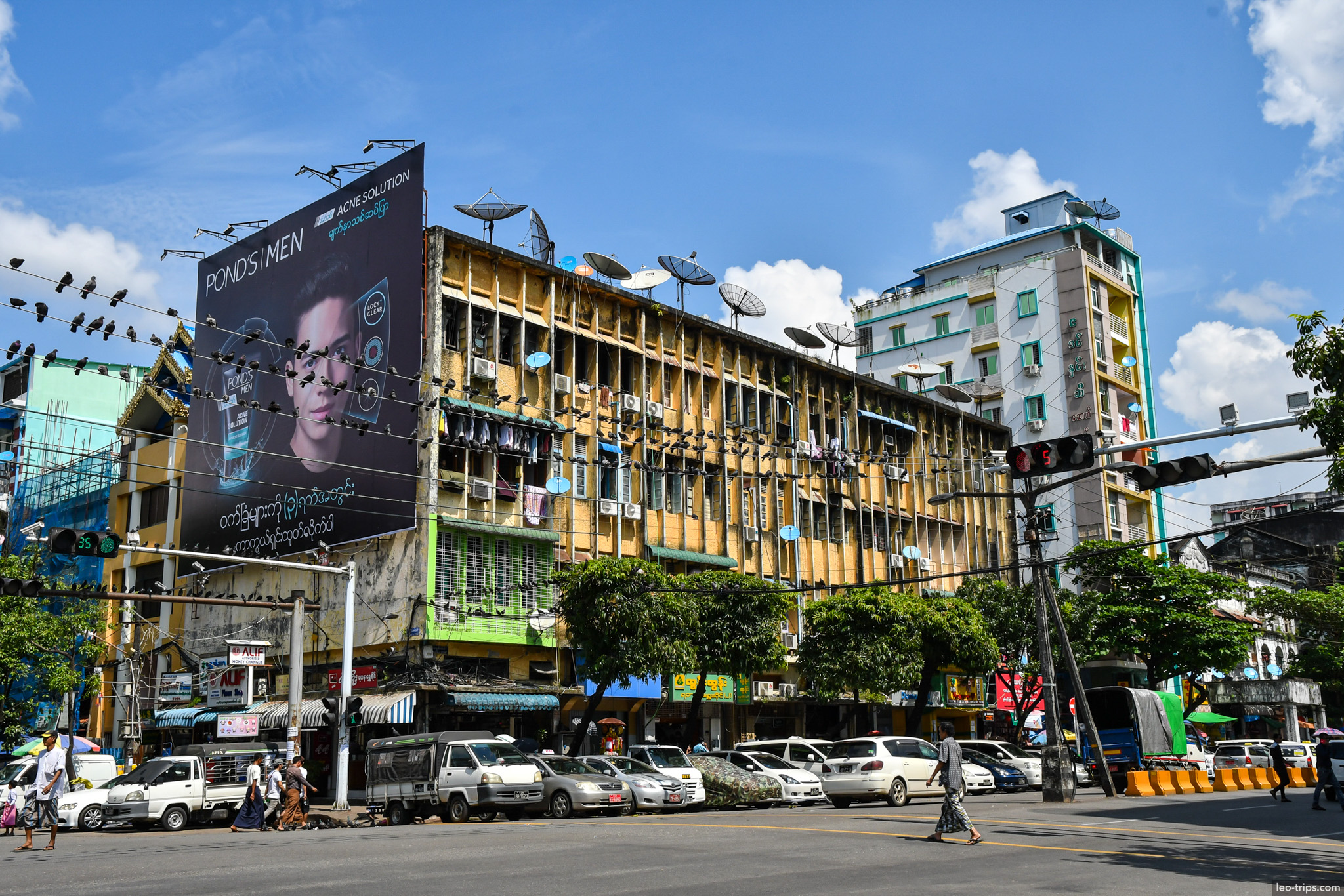 yangon downtown intersection worn building billboard pigeons yangon