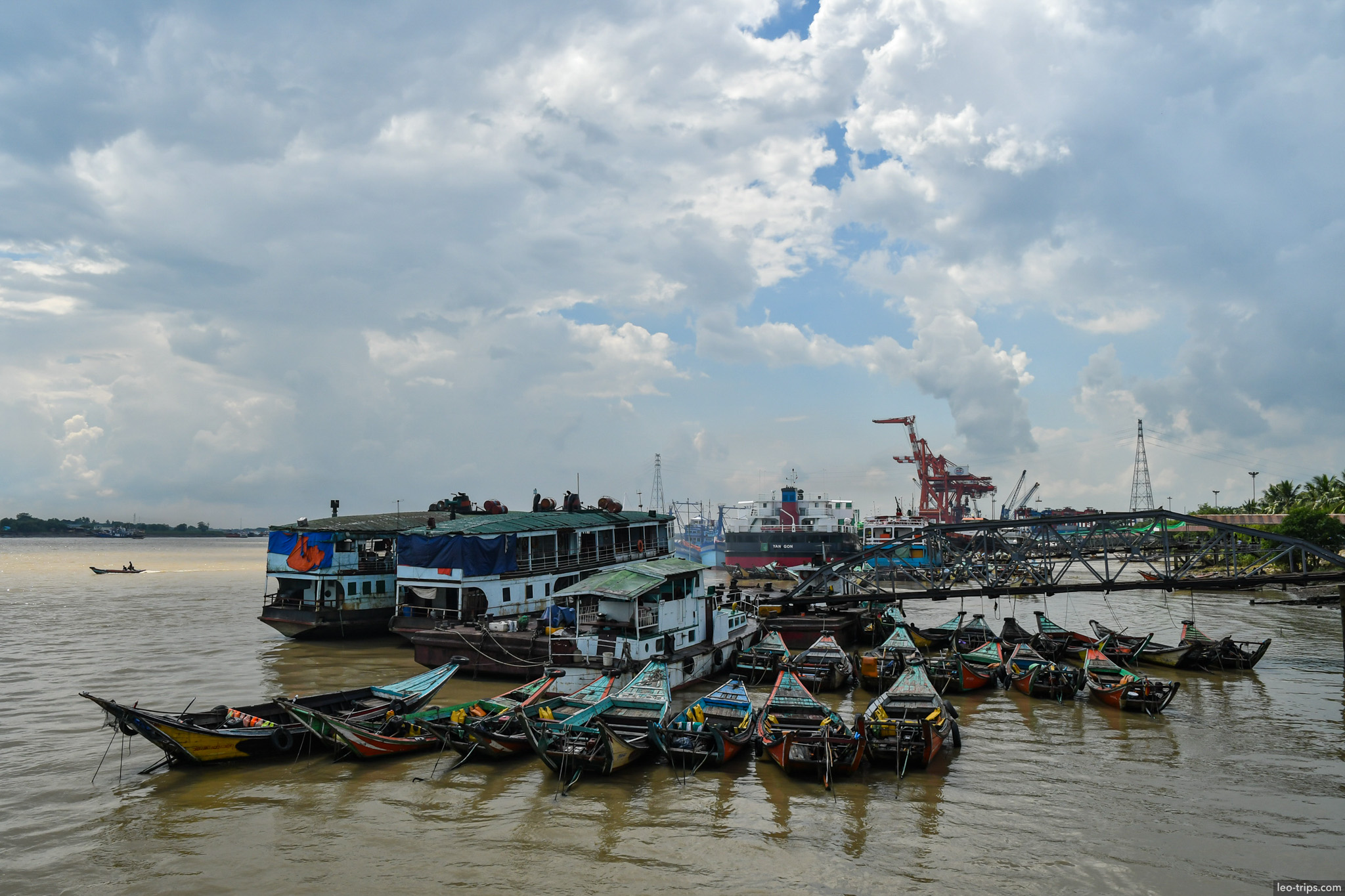 yangon river boats docked port cargo cranes background yangon