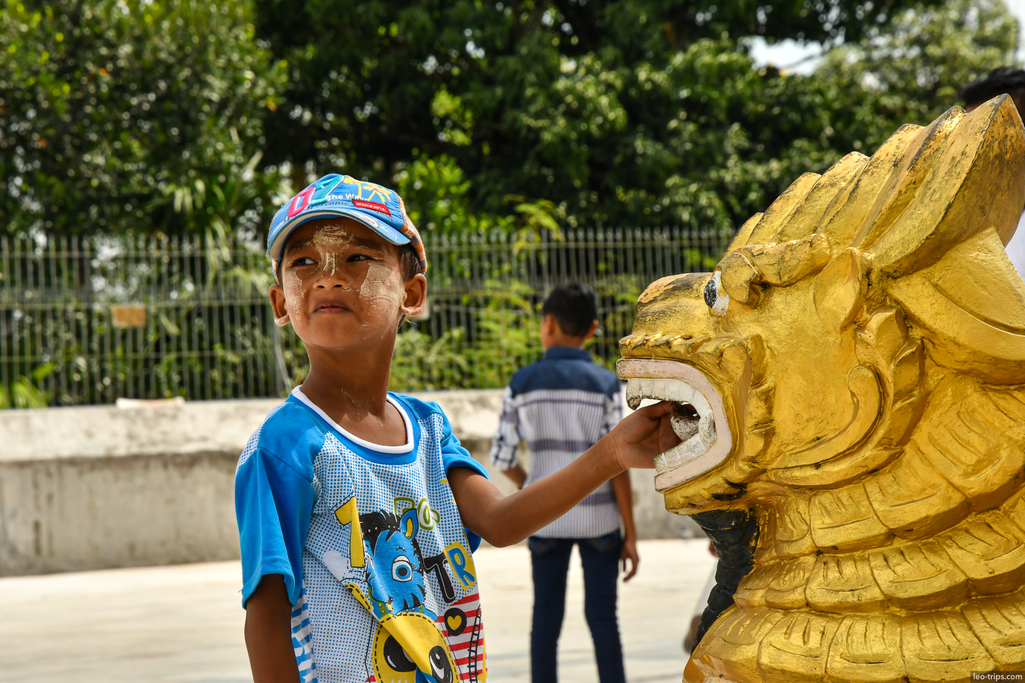 yangon shwedagon pagoda burmese boy touching golden lion yangon