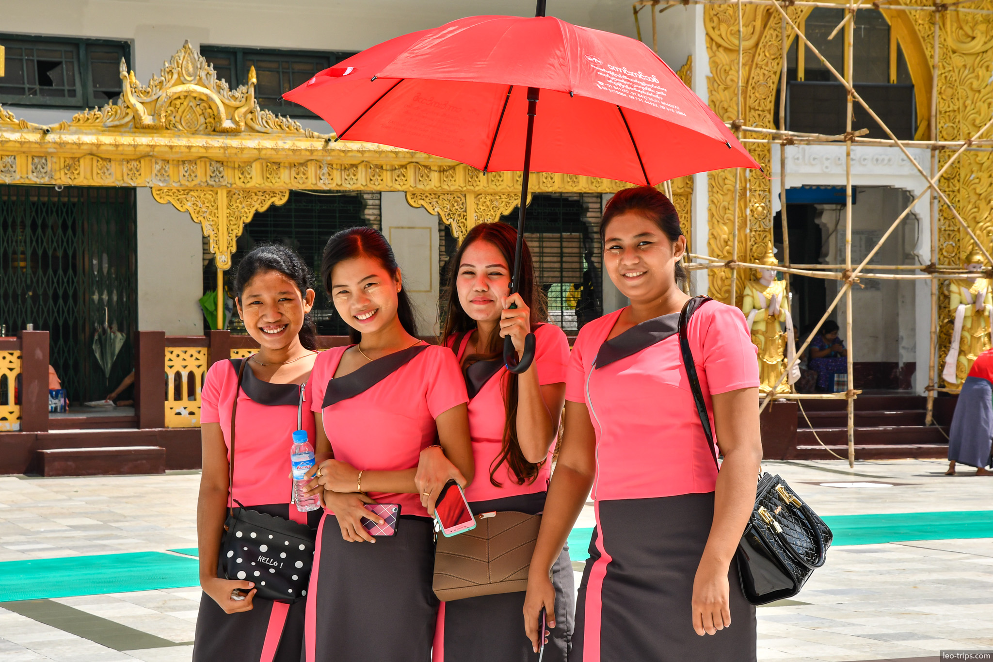 yangon shwedagon pagoda four girls pink uniforms red umbrella yangon