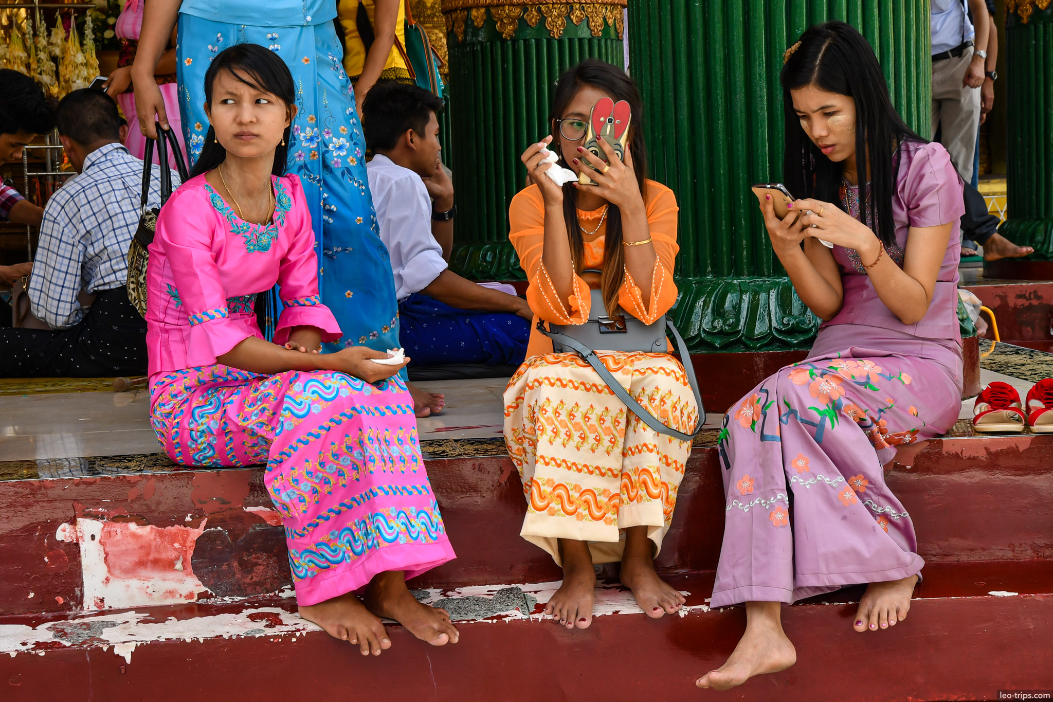 yangon shwedagon pagoda three women colorful dresses phones yangon