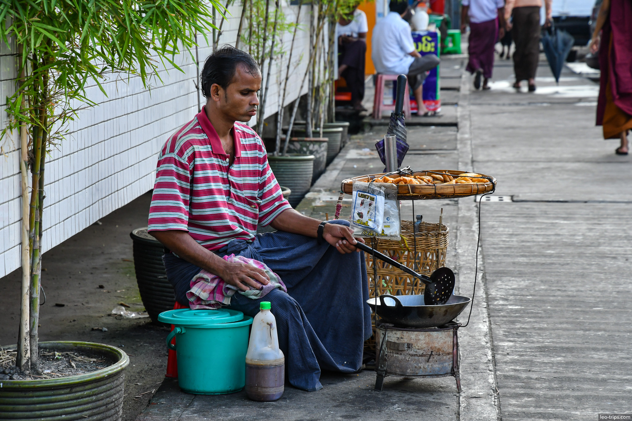 yangon street food vendor frying snacks sidewalk monk yangon