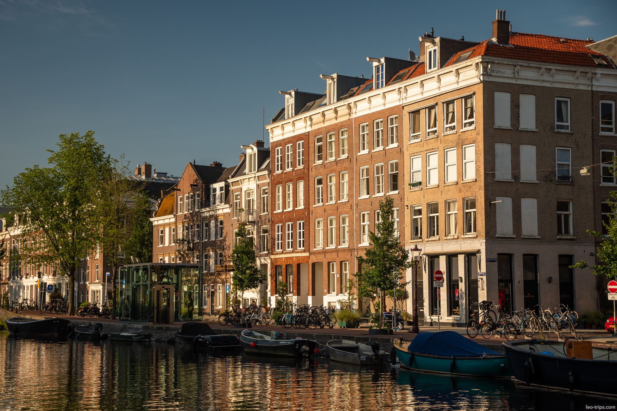 amsterdam canal with brick buildings and boats amsterdam