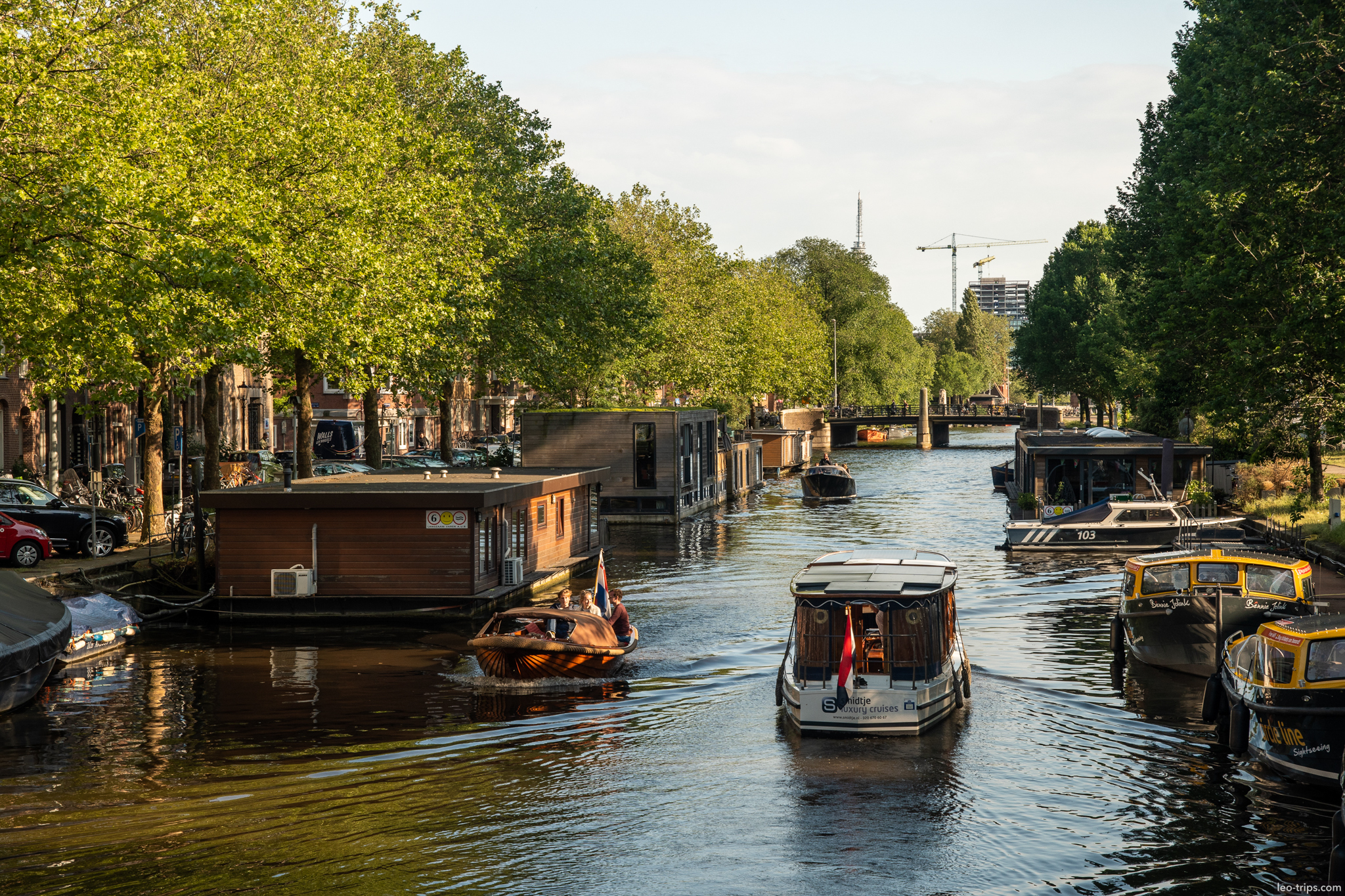 amsterdam canal with houseboats and trees amsterdam