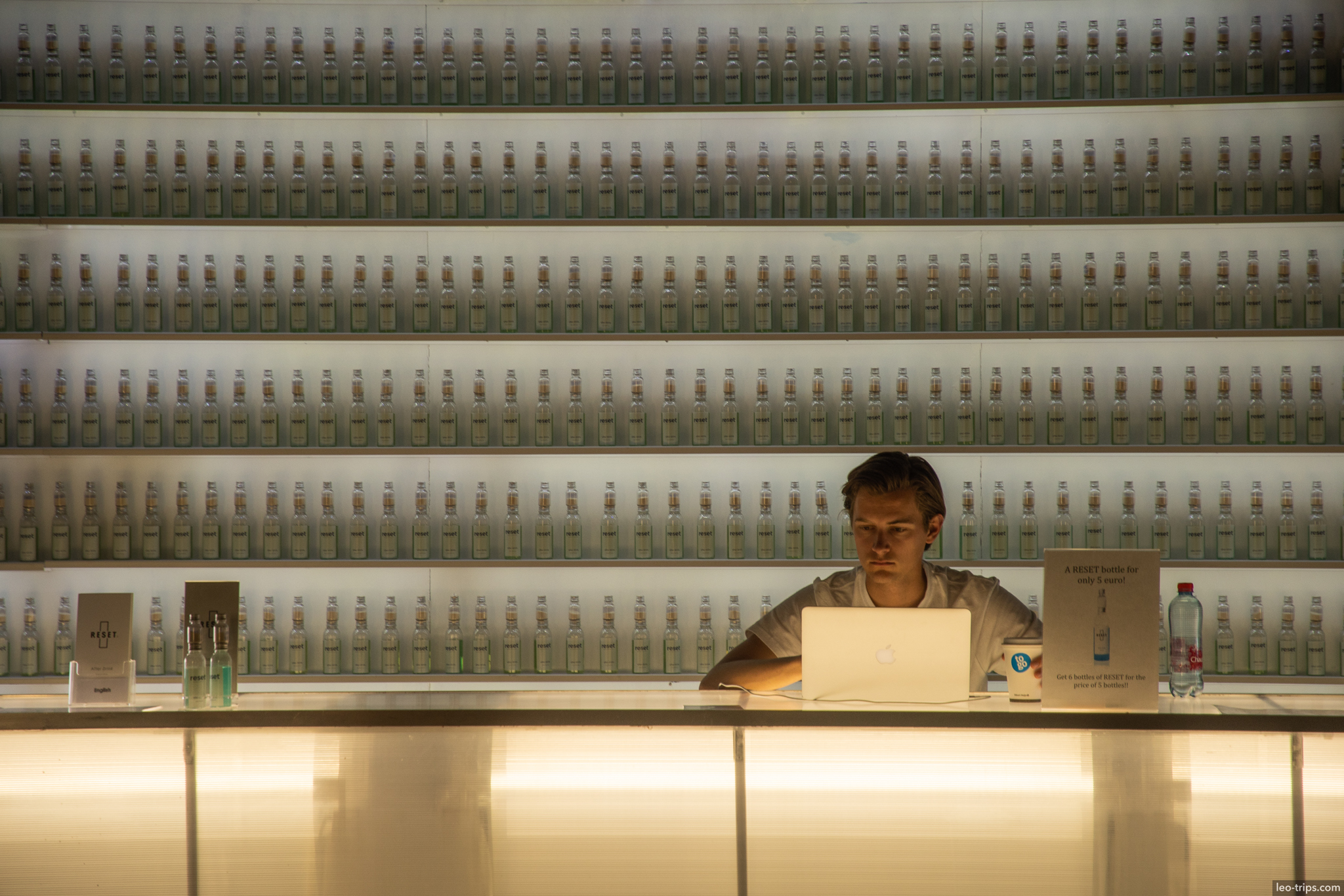 bartender working behind bar bottles wall amsterdam