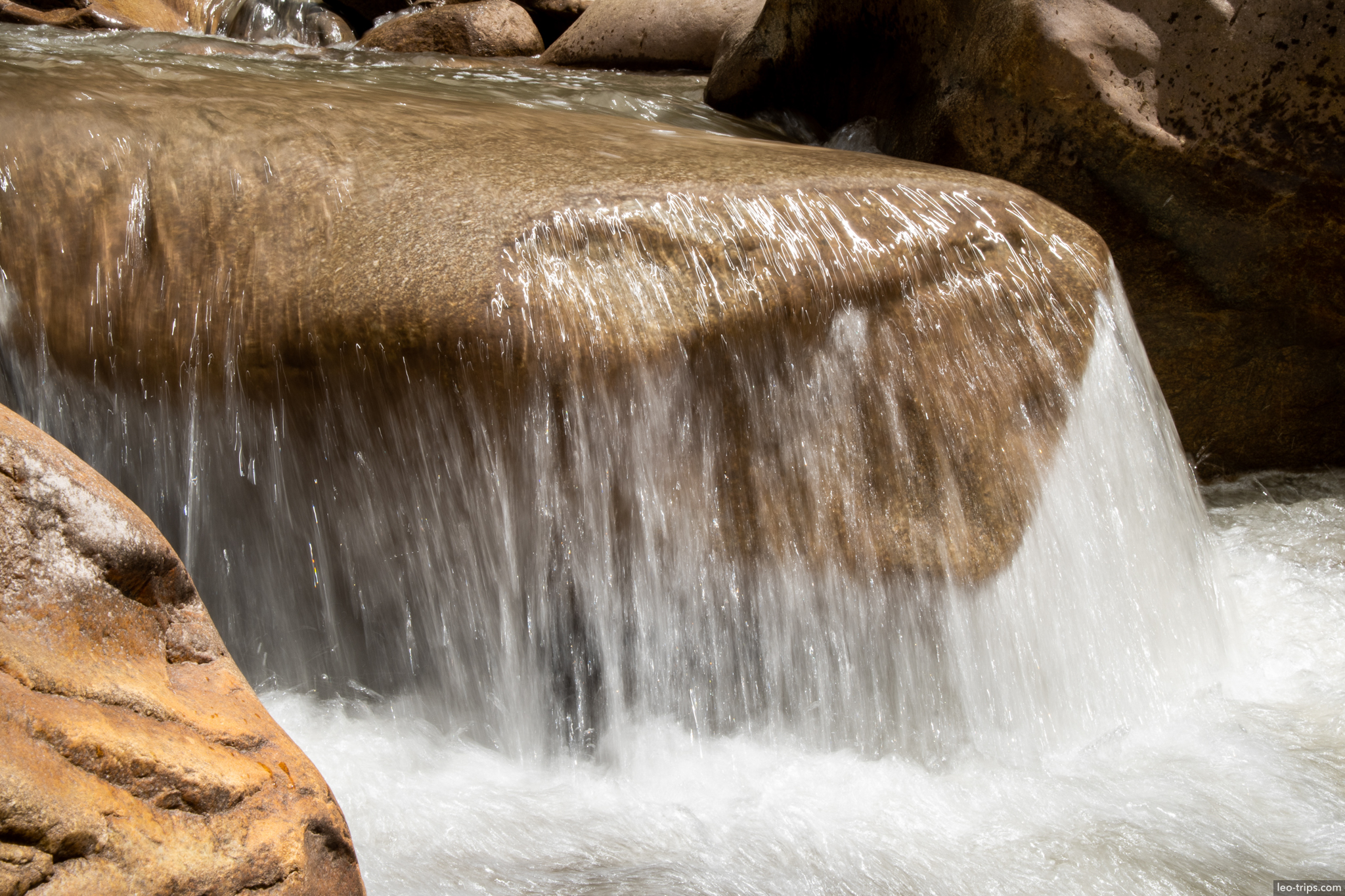 urubamba river waterfall over boulder around aguas calientes