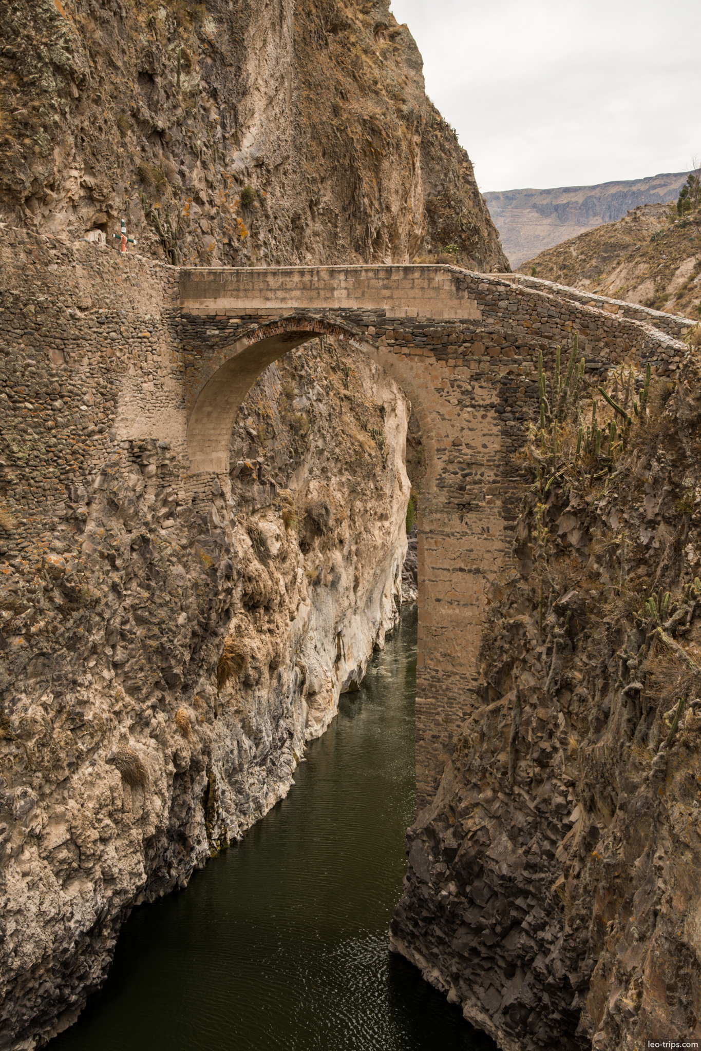 stone arch bridge over colca river canyon colca canyon