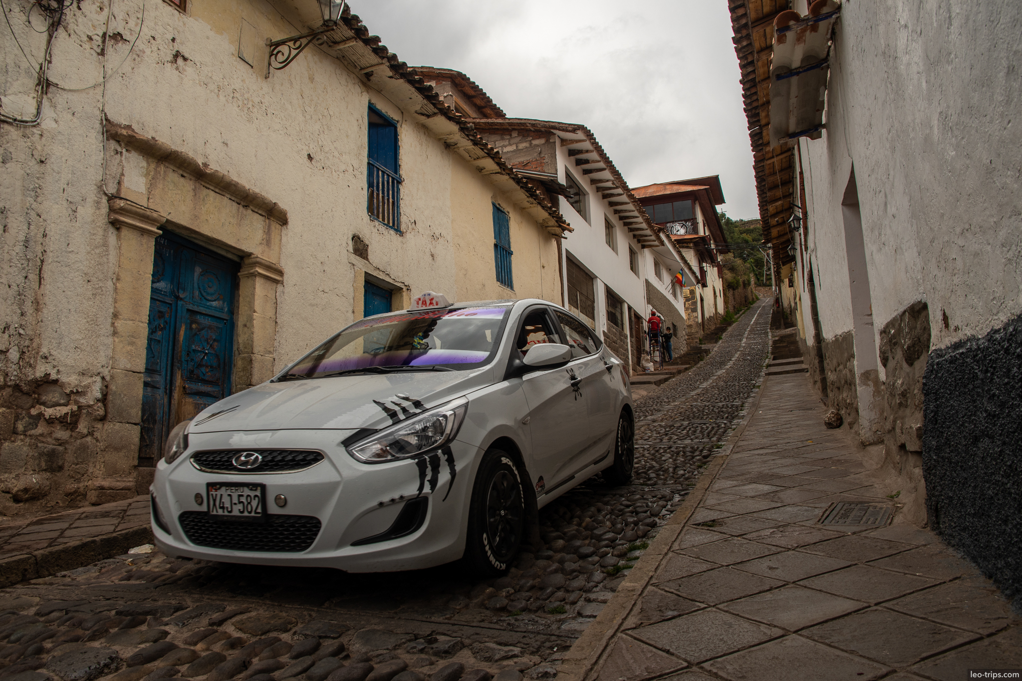 hyundai taxi narrow cobblestone street cusco
