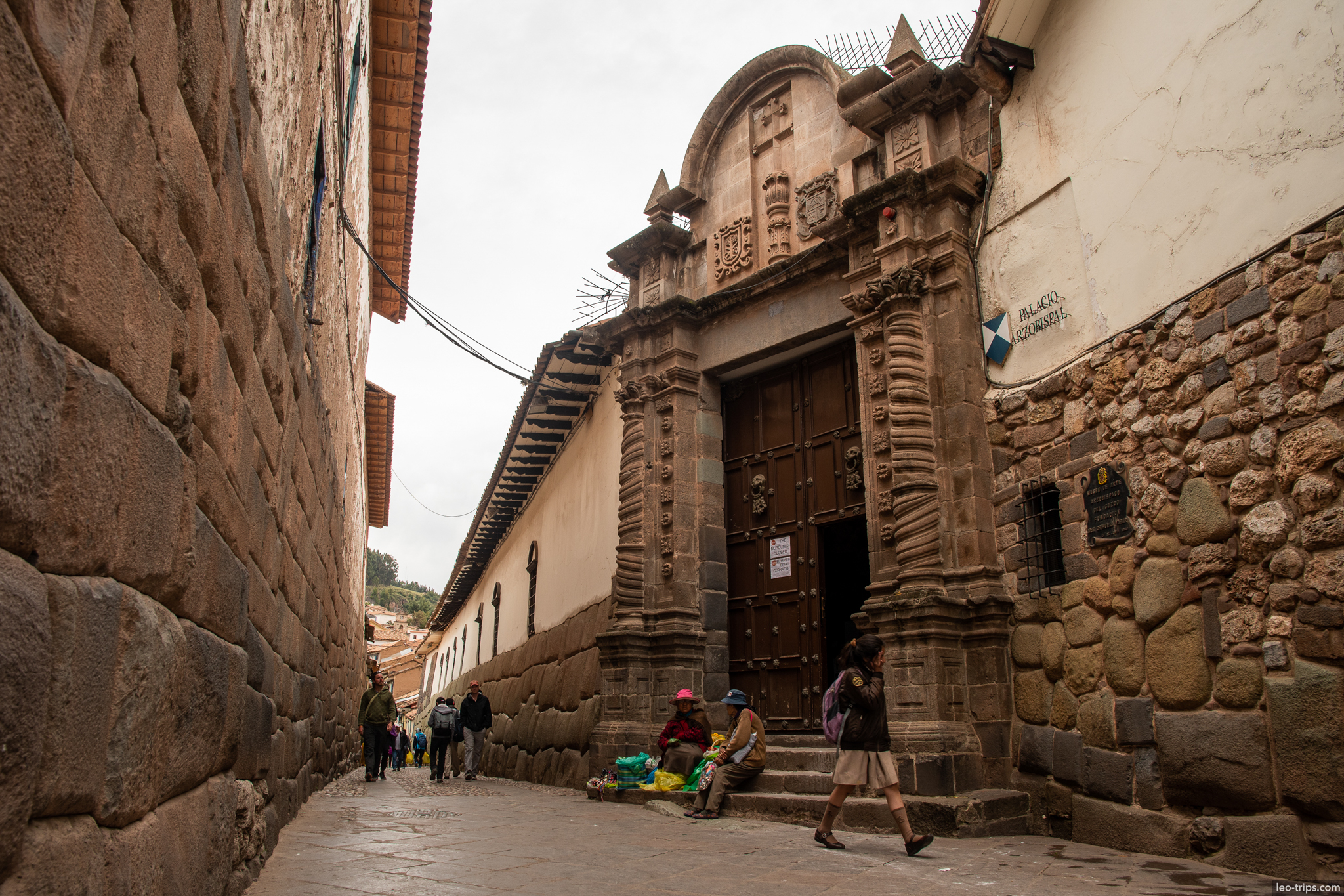 palacio arzobispal baroque portal narrow street cusco