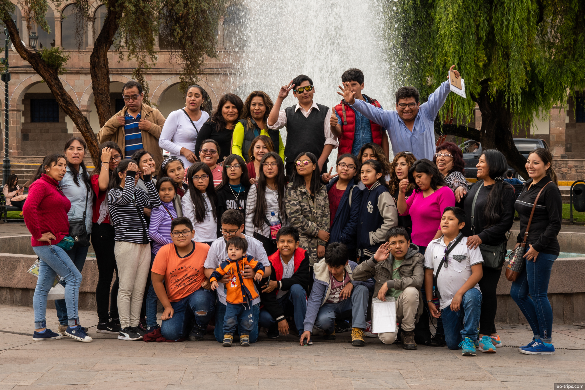 peruvian family group photo plaza fountain cusco