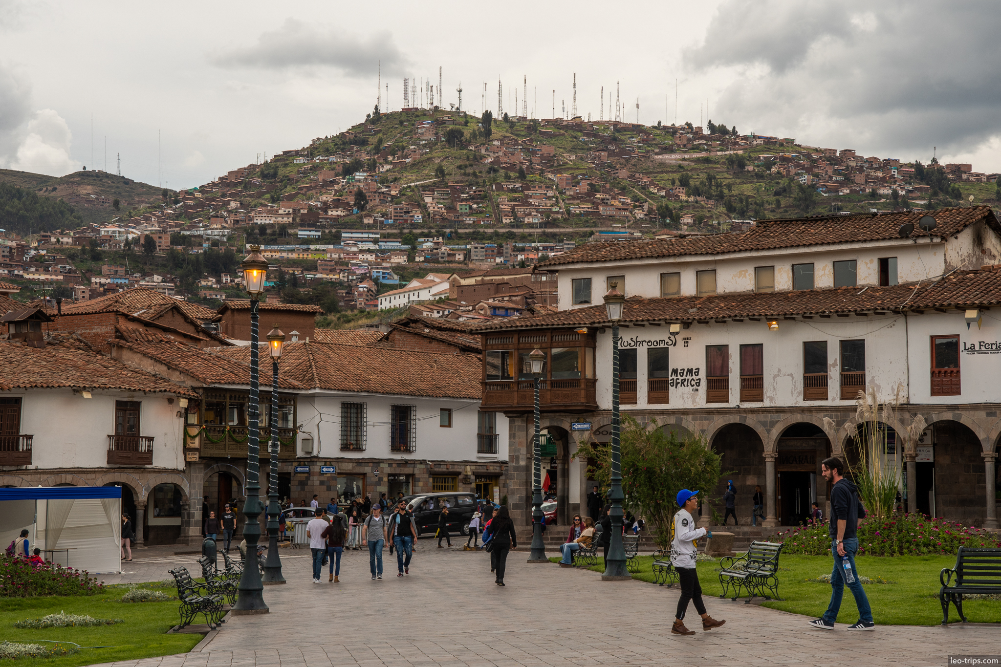 plaza de armas colonial arcade hill background cusco