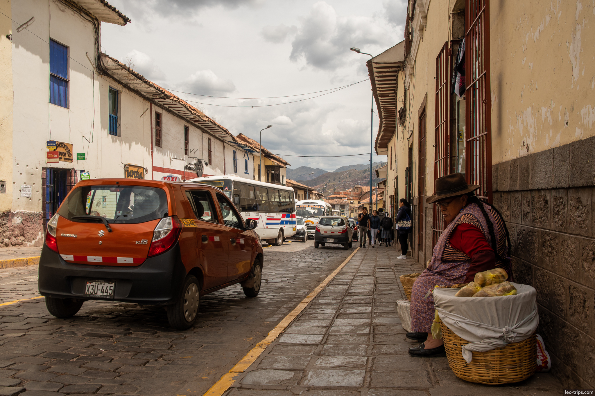 quechua woman selling food street sidewalk cusco