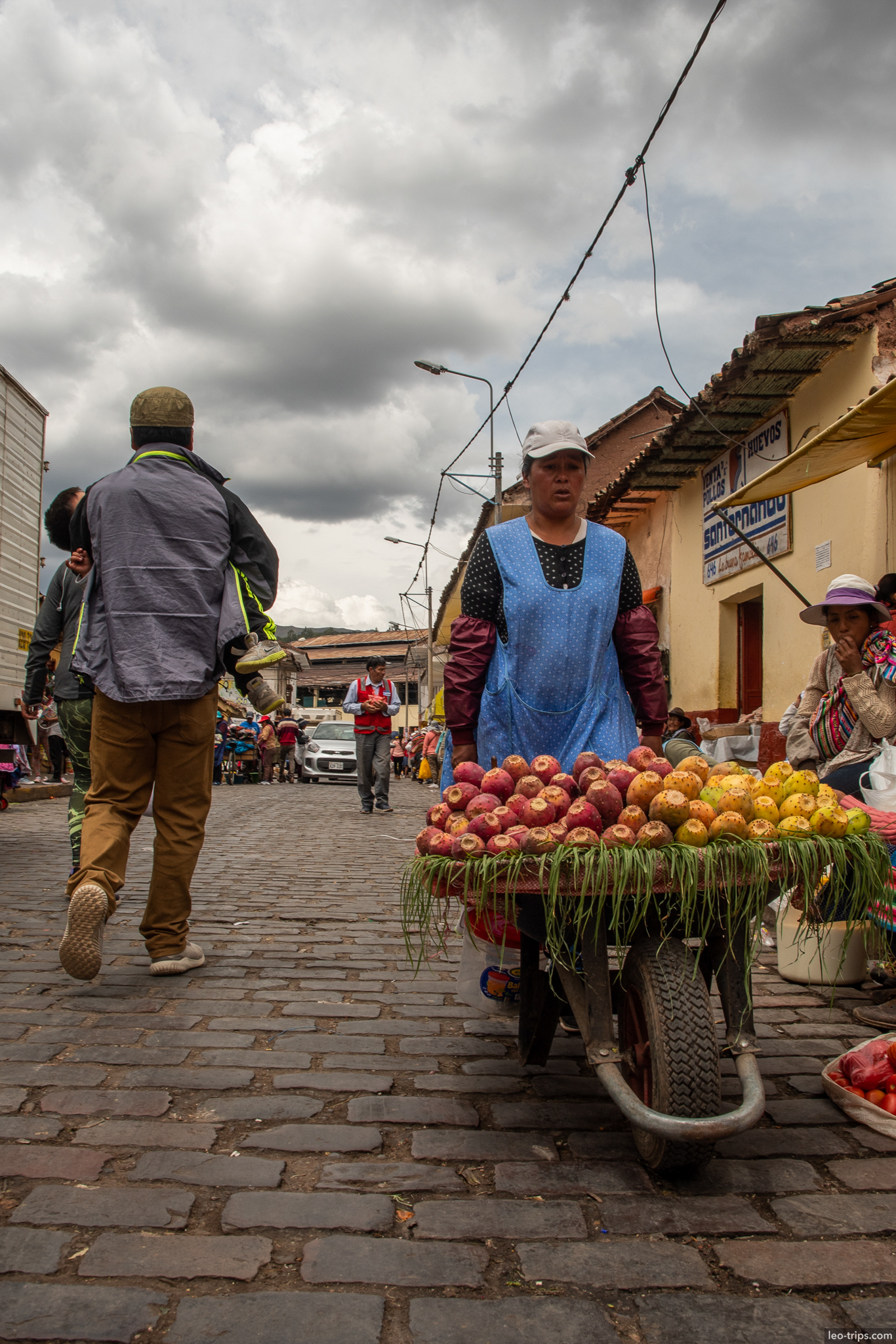 street vendor wheelbarrow apples market cusco