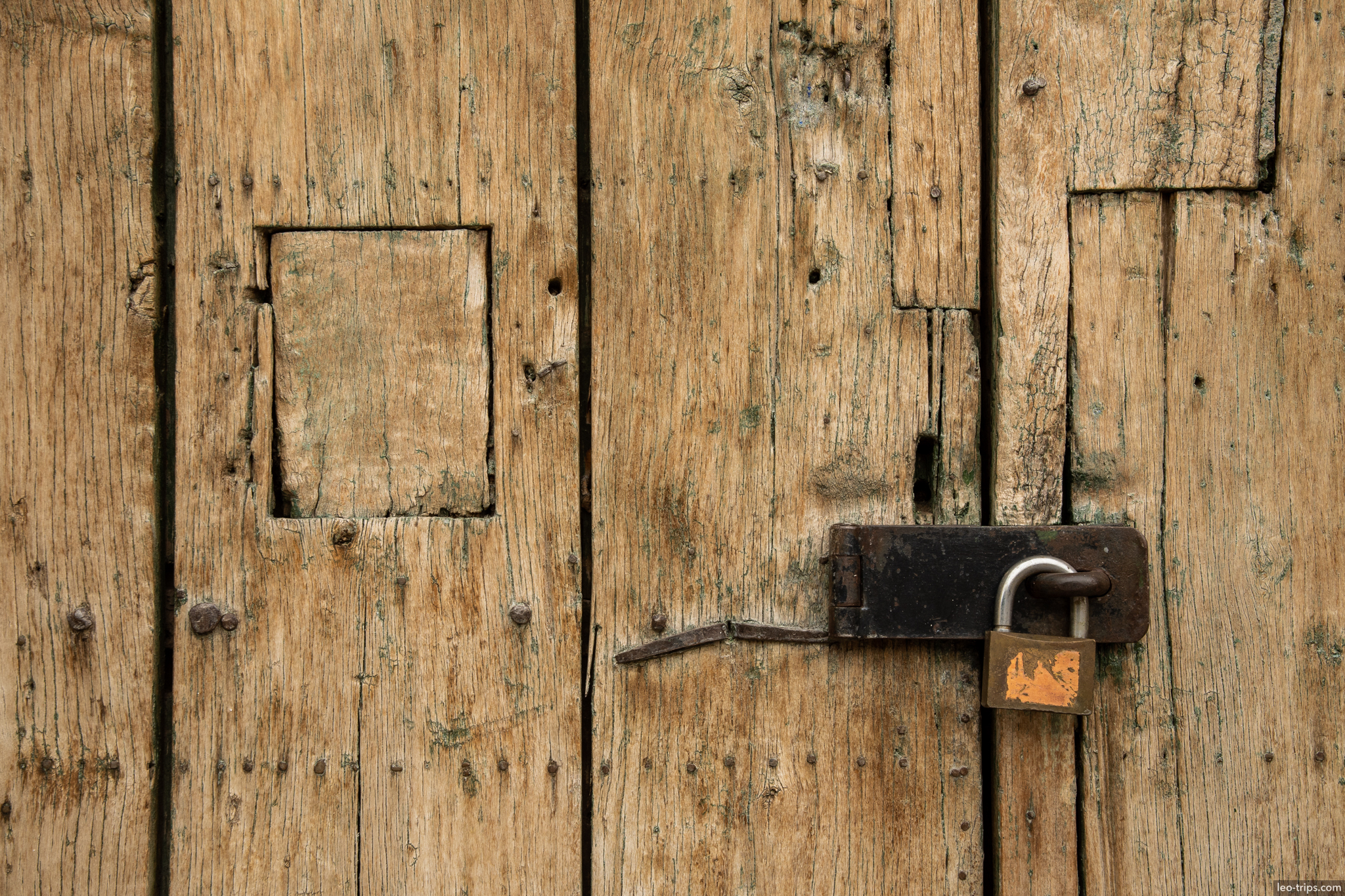 weathered wooden door with padlock cusco