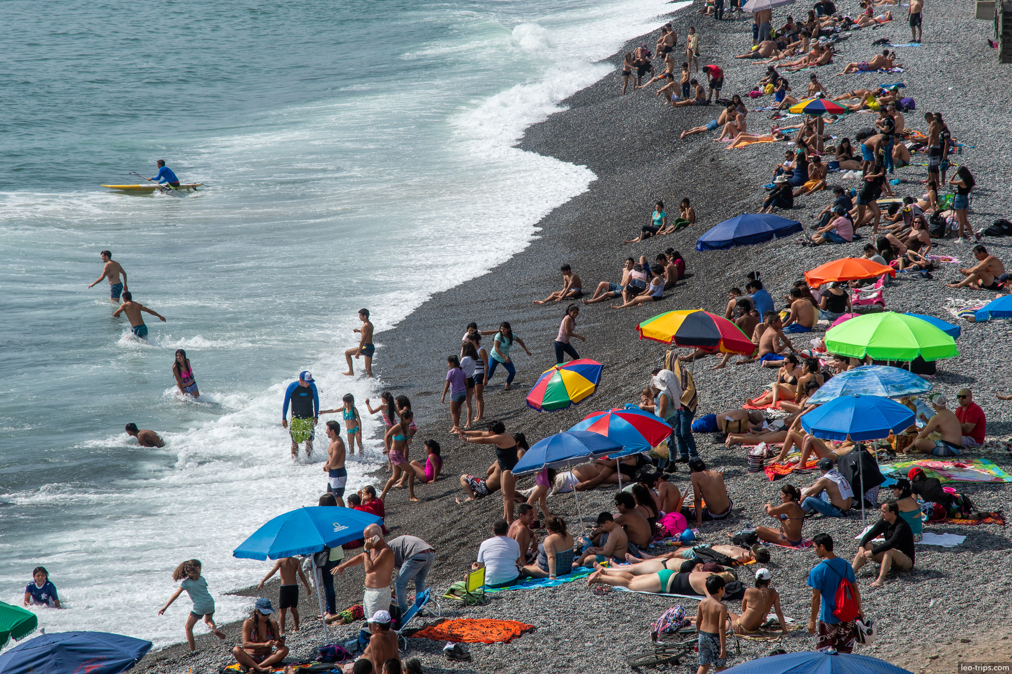 miraflores beach crowded colorful umbrellas lima