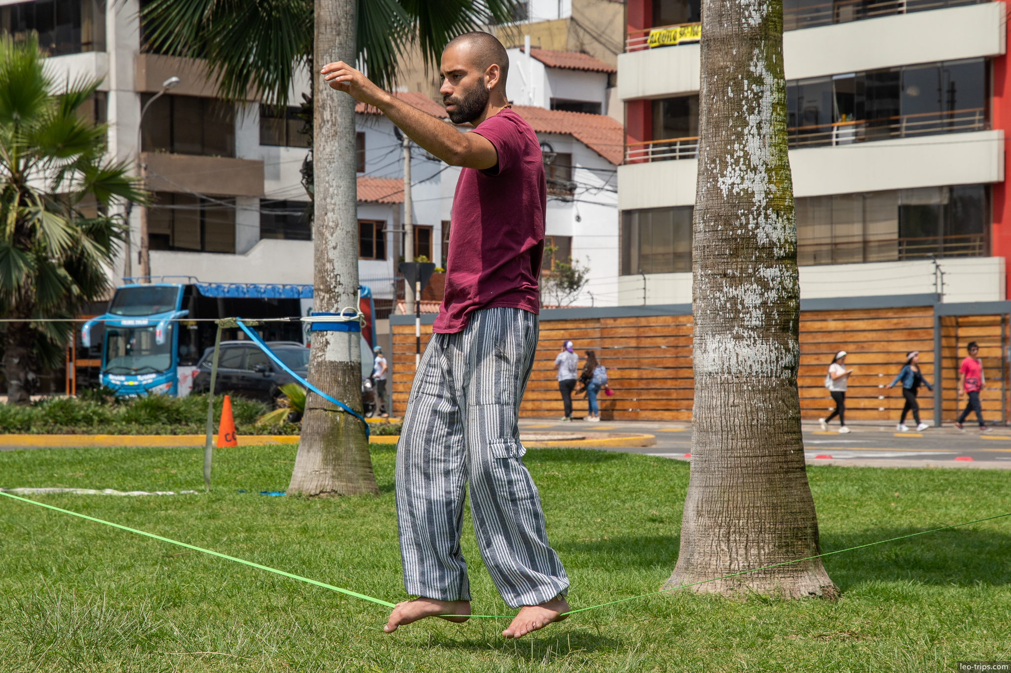slackline man miraflores park palm trees lima