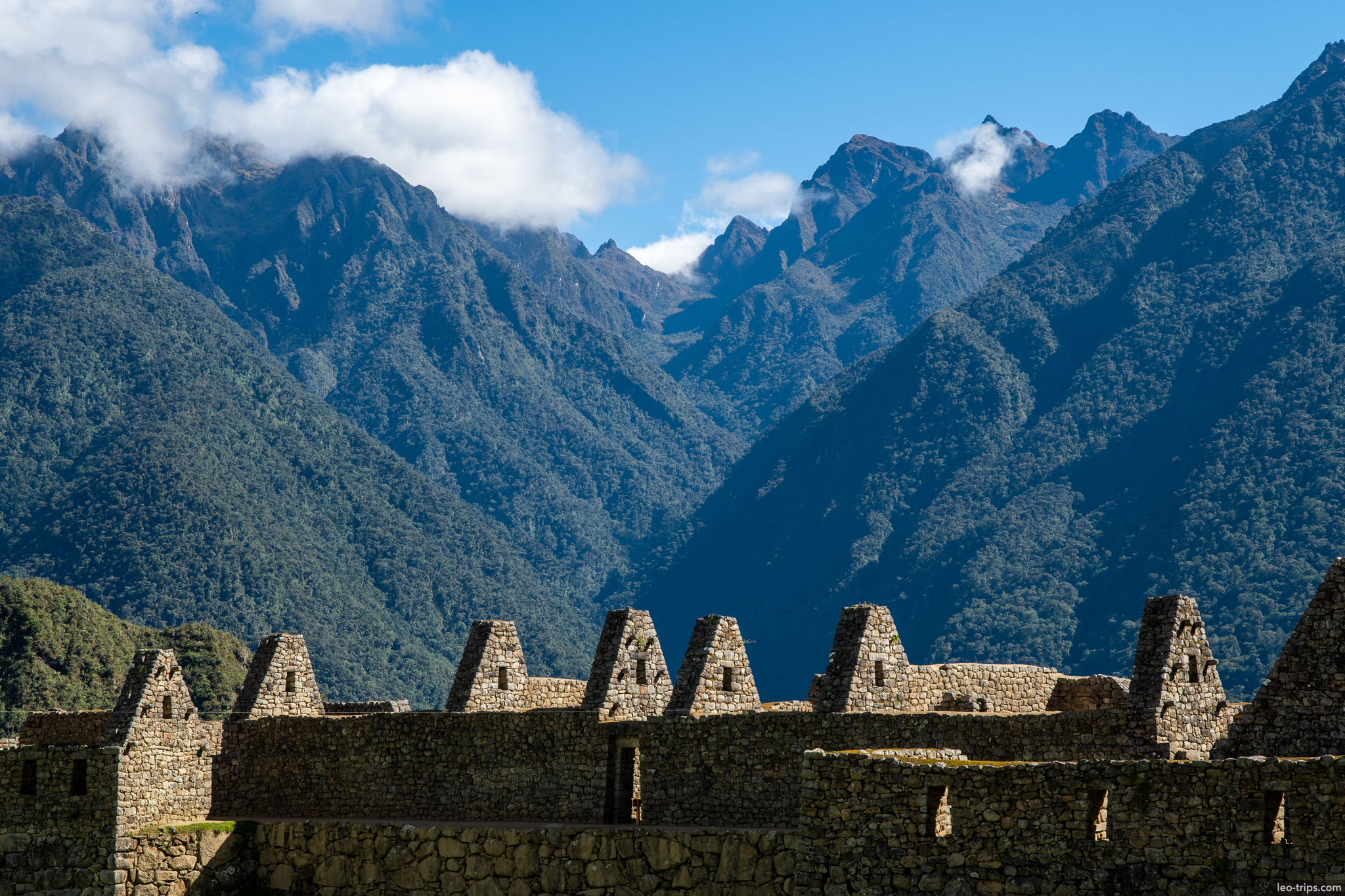 residential gabled houses row andes backdrop machu picchu