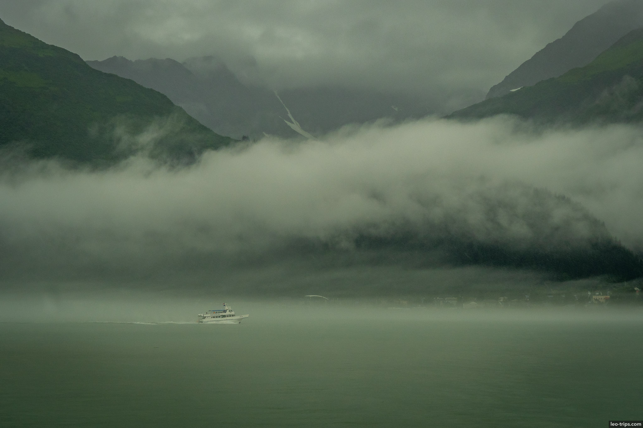 Boat and Mountains with low clouds resurrection bay