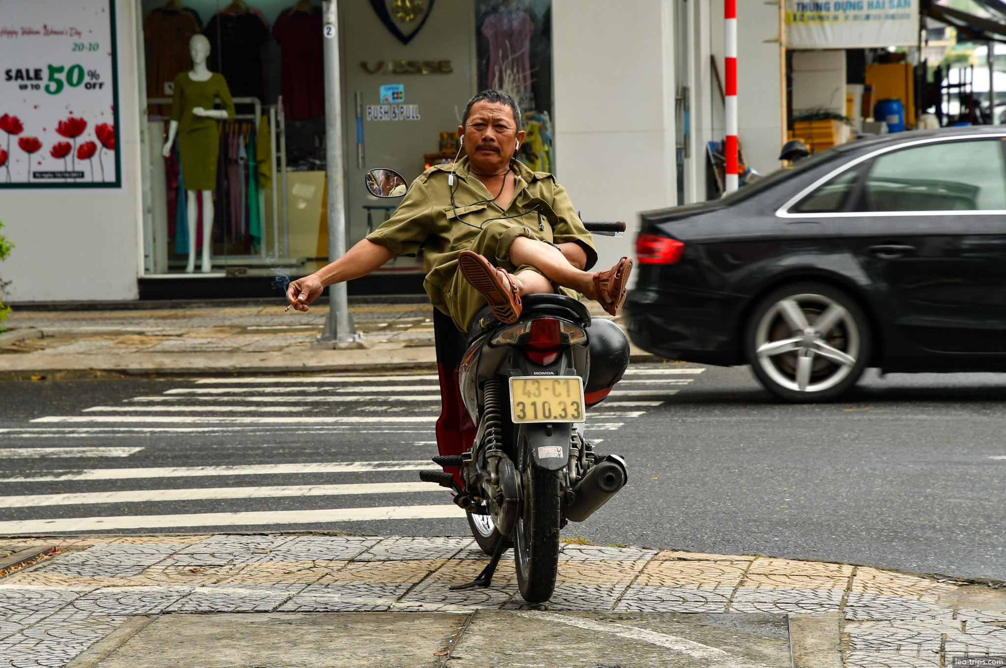 vietnamese man riding motorcycle feet up danang da nang