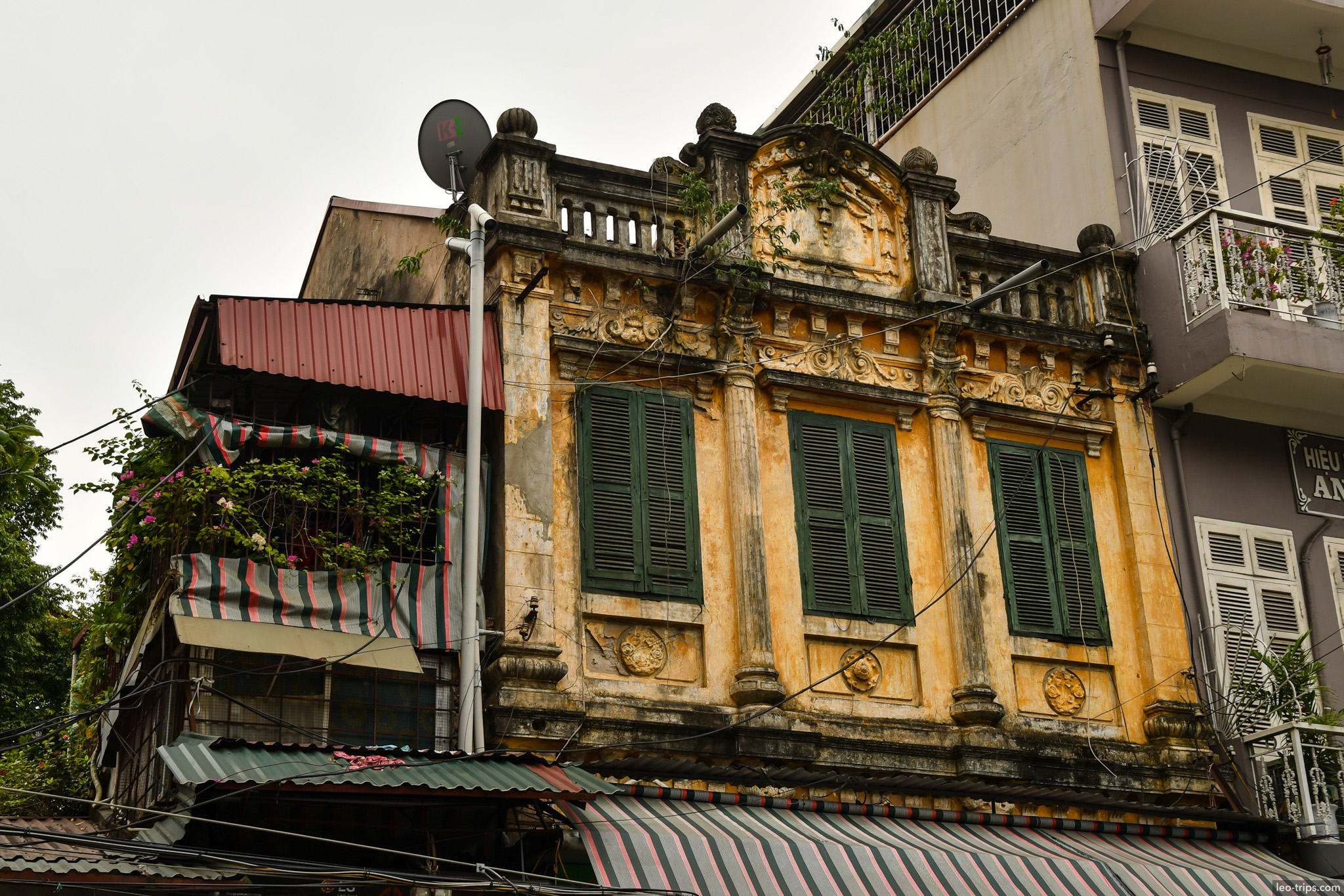 crumbling french colonial facade green shutters hanoi hanoi