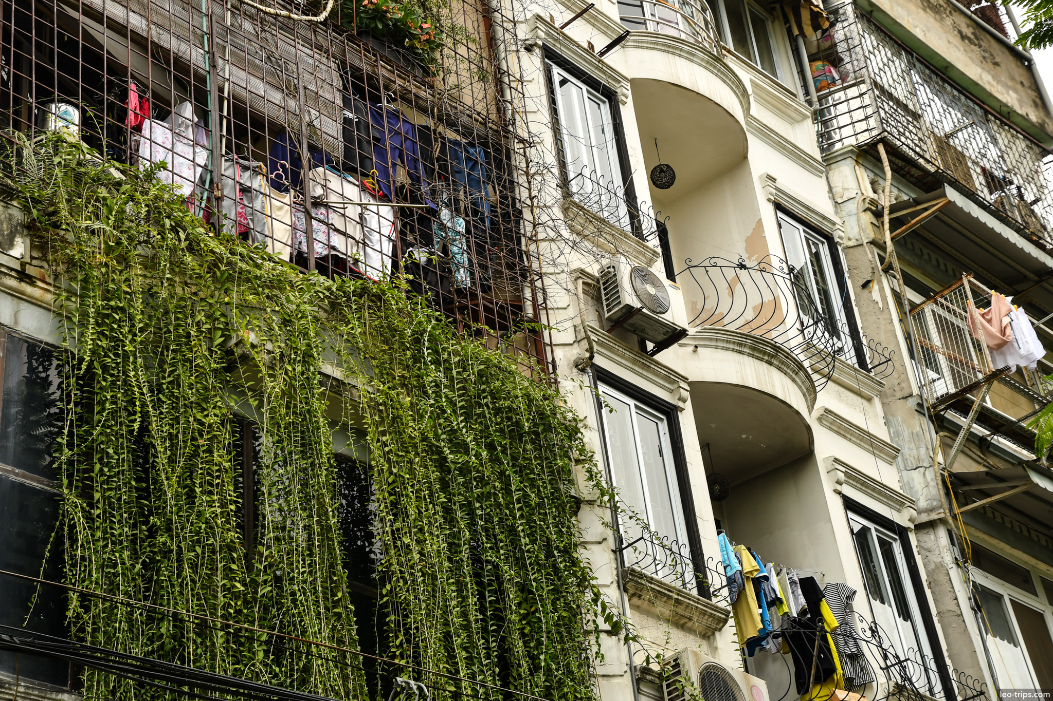 french colonial apartment building vines balconies hanoi hanoi
