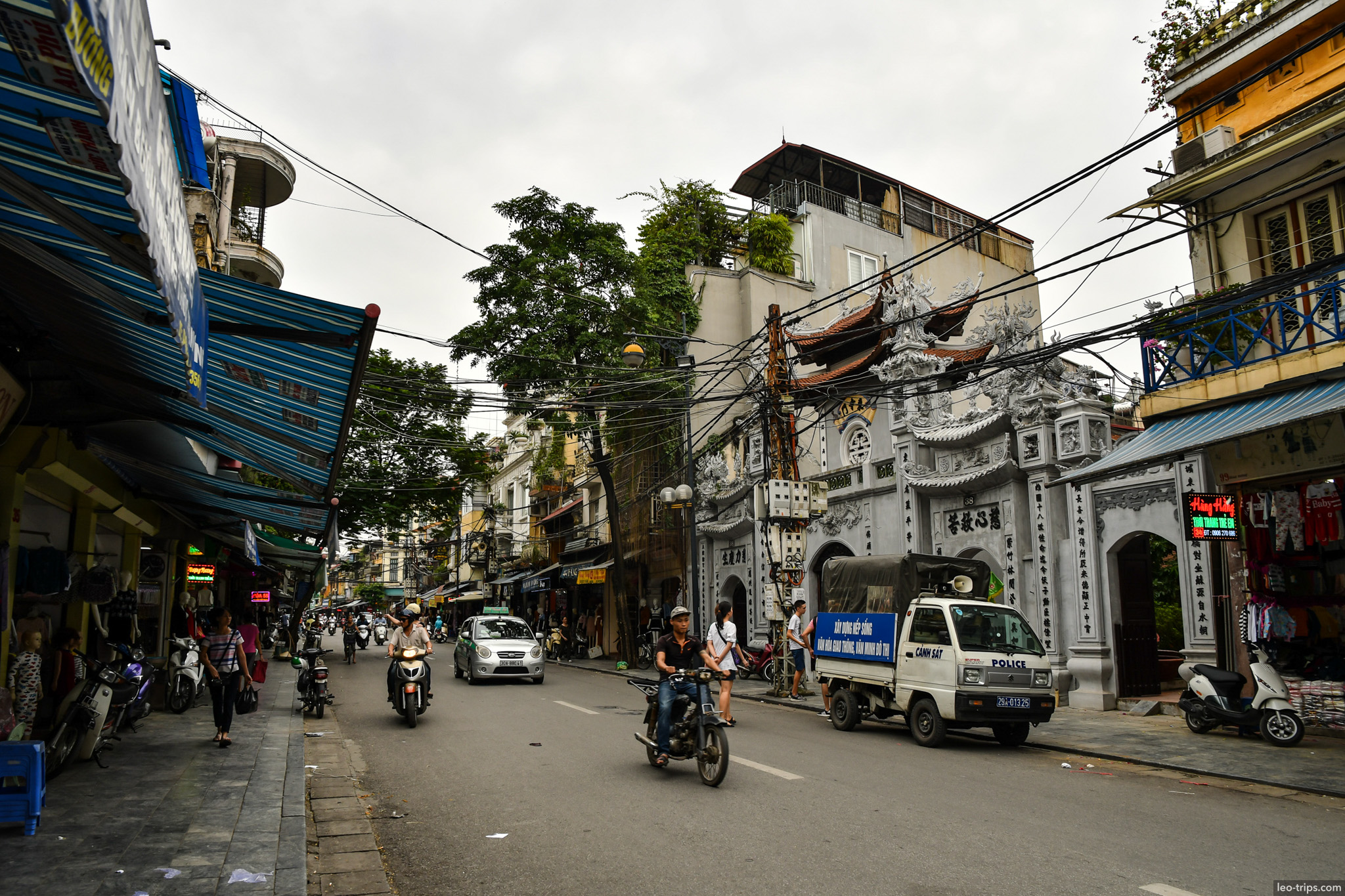 old quarter street white temple gate police truck hanoi hanoi