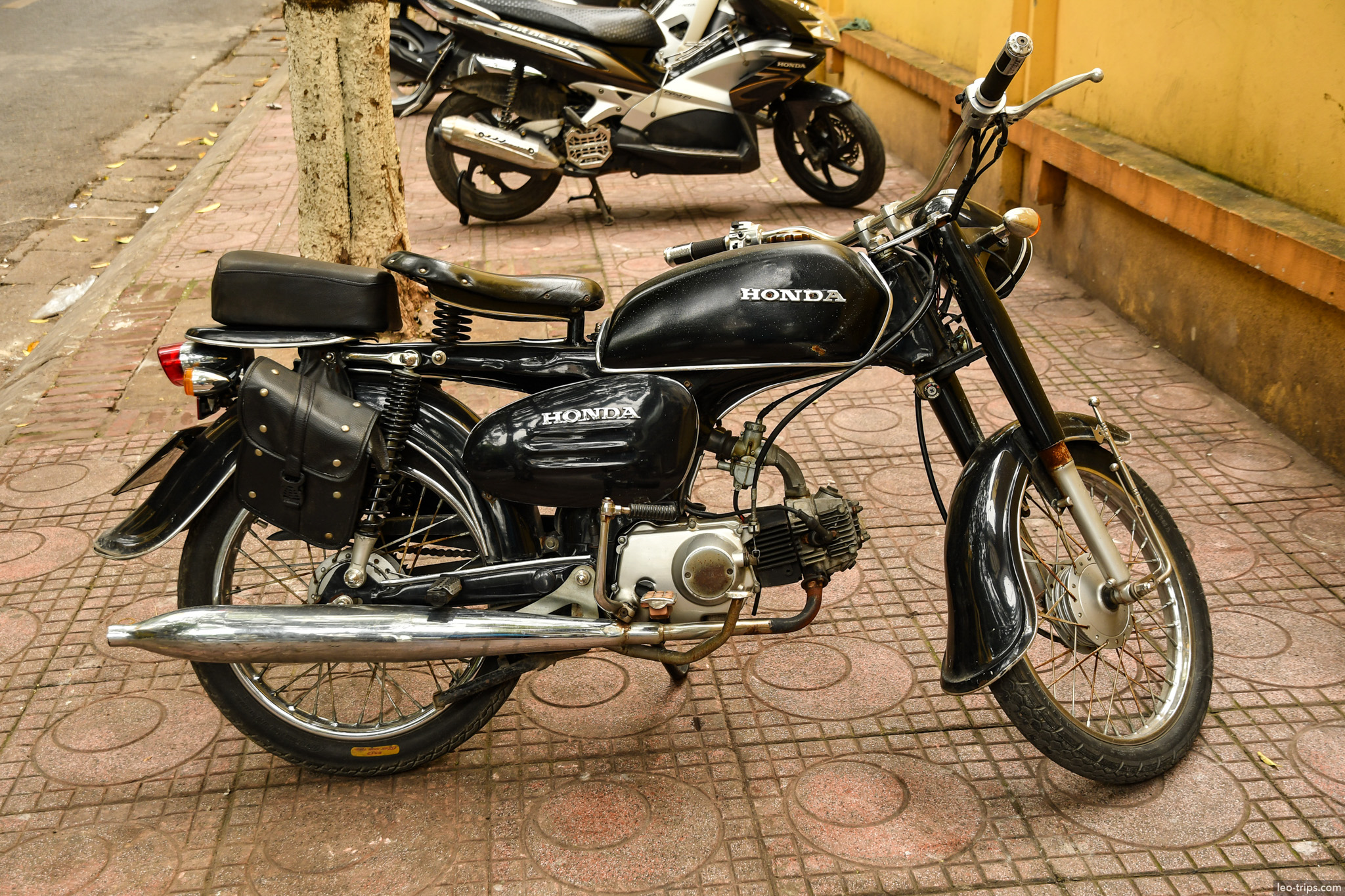 vintage black honda motorcycle parked sidewalk hanoi hanoi