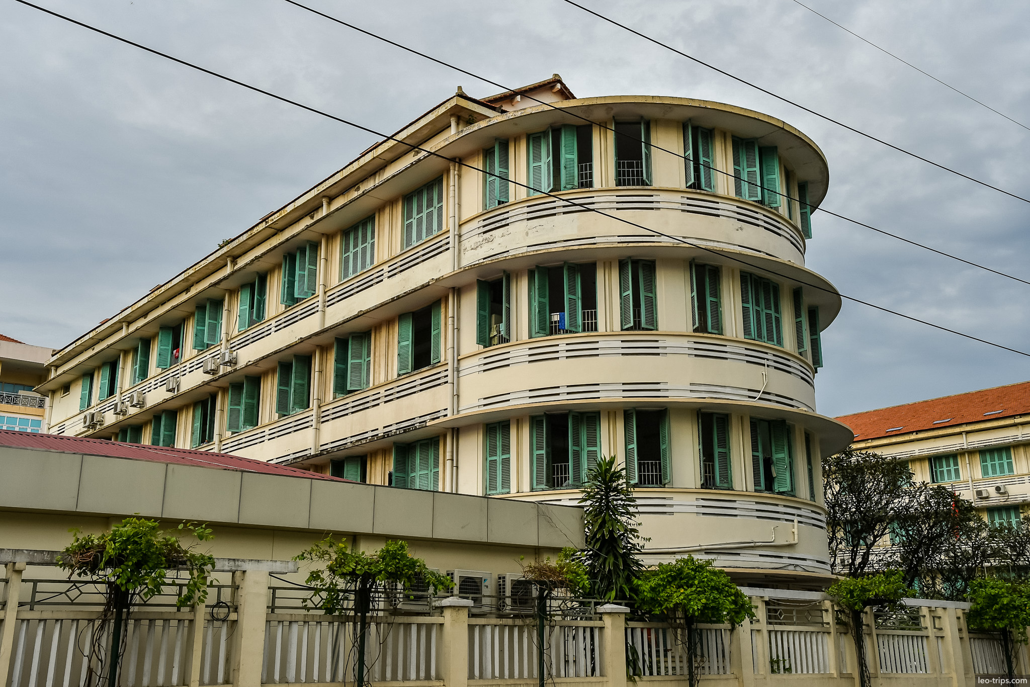art deco round corner building green shutters ho chi minh city