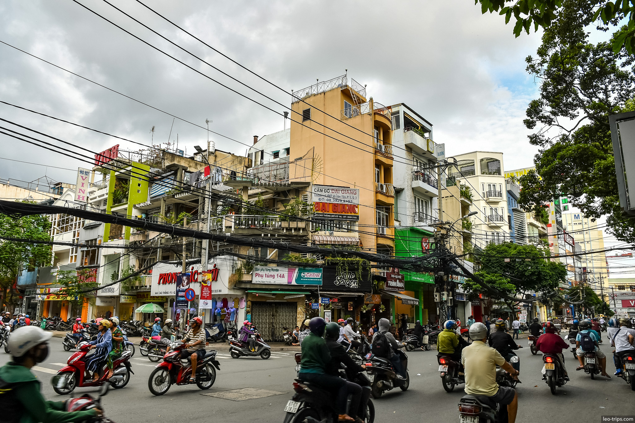 busy intersection narrow buildings little saigon ho chi minh city