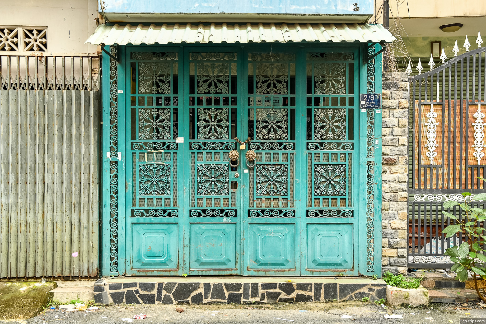 ornate turquoise iron door saigon house ho chi minh city