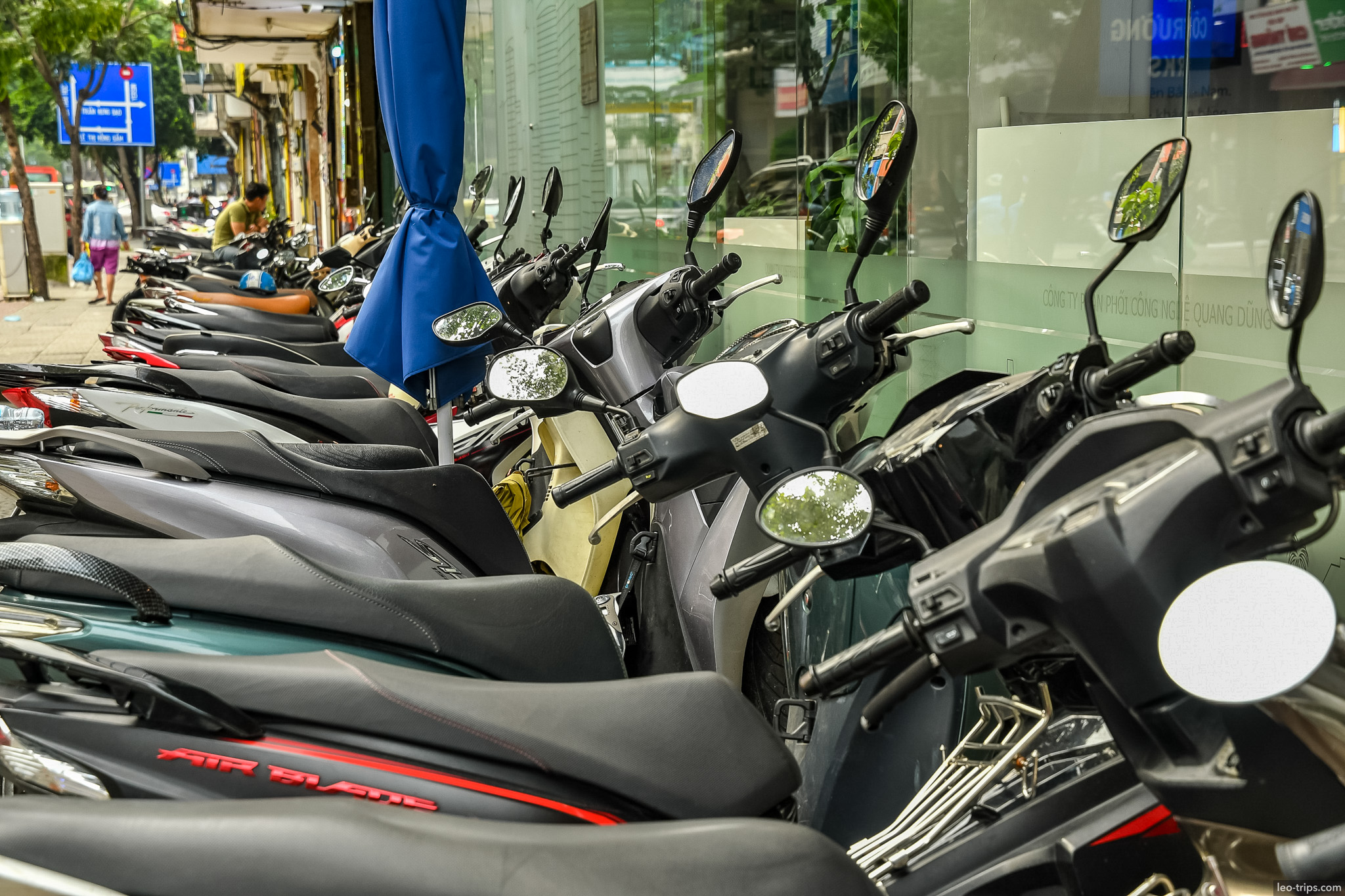 row of parked scooters saigon sidewalk ho chi minh city