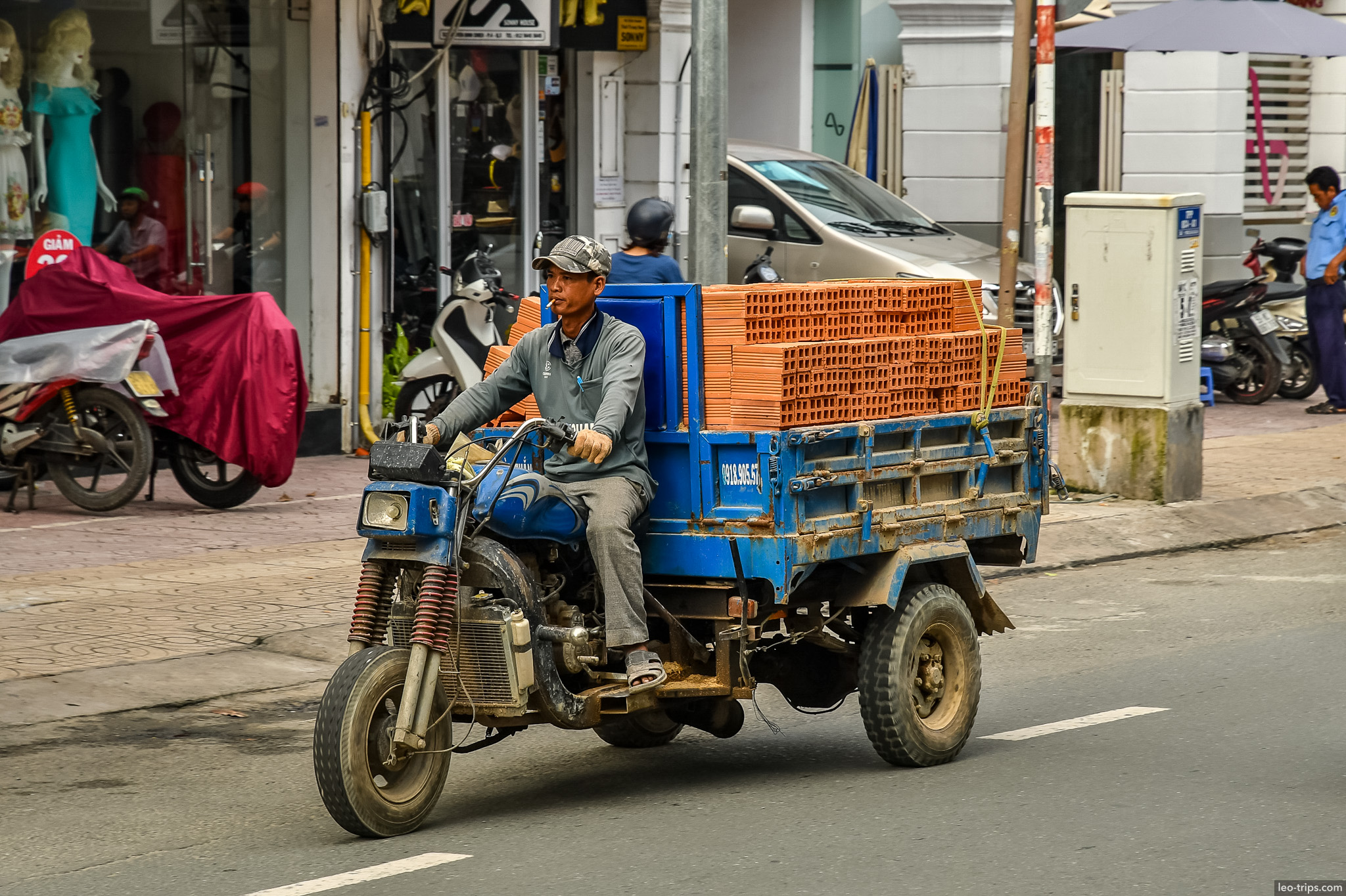 three wheel motorbike carrying bricks saigon ho chi minh city