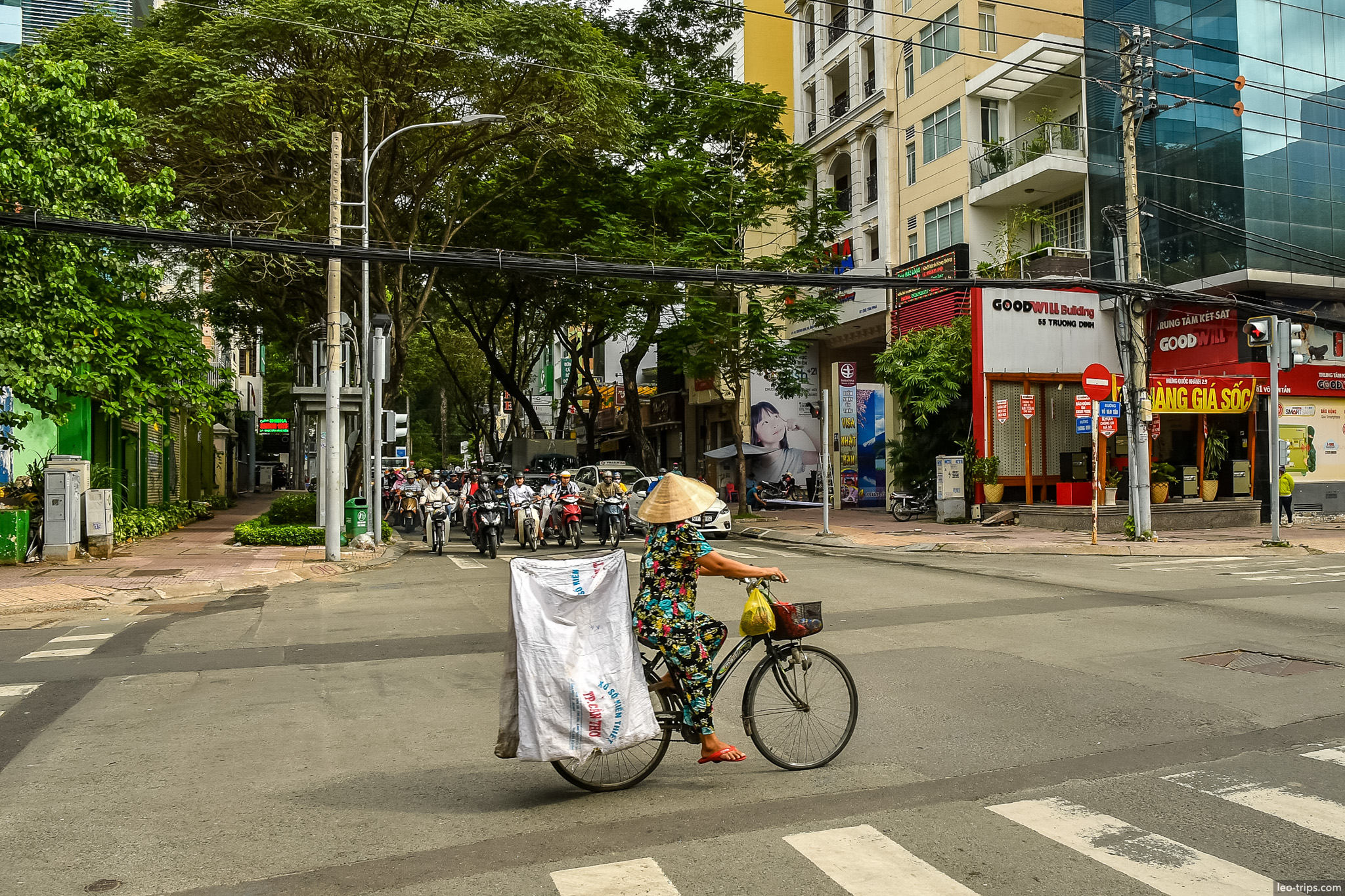 woman conical hat bicycle crossing street saigon ho chi minh city